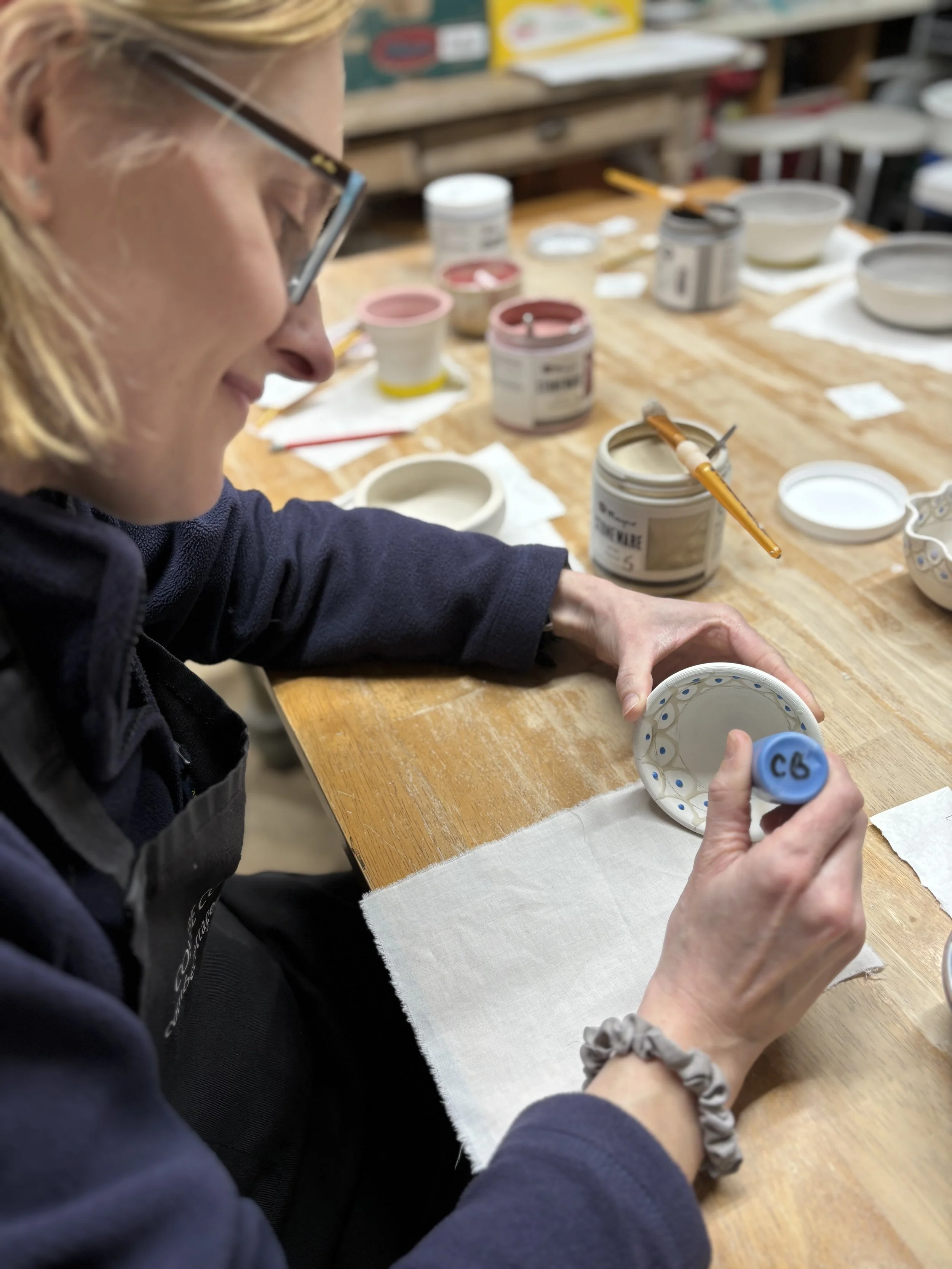   
 ... carefully applying glazes to all their pieces! 
 