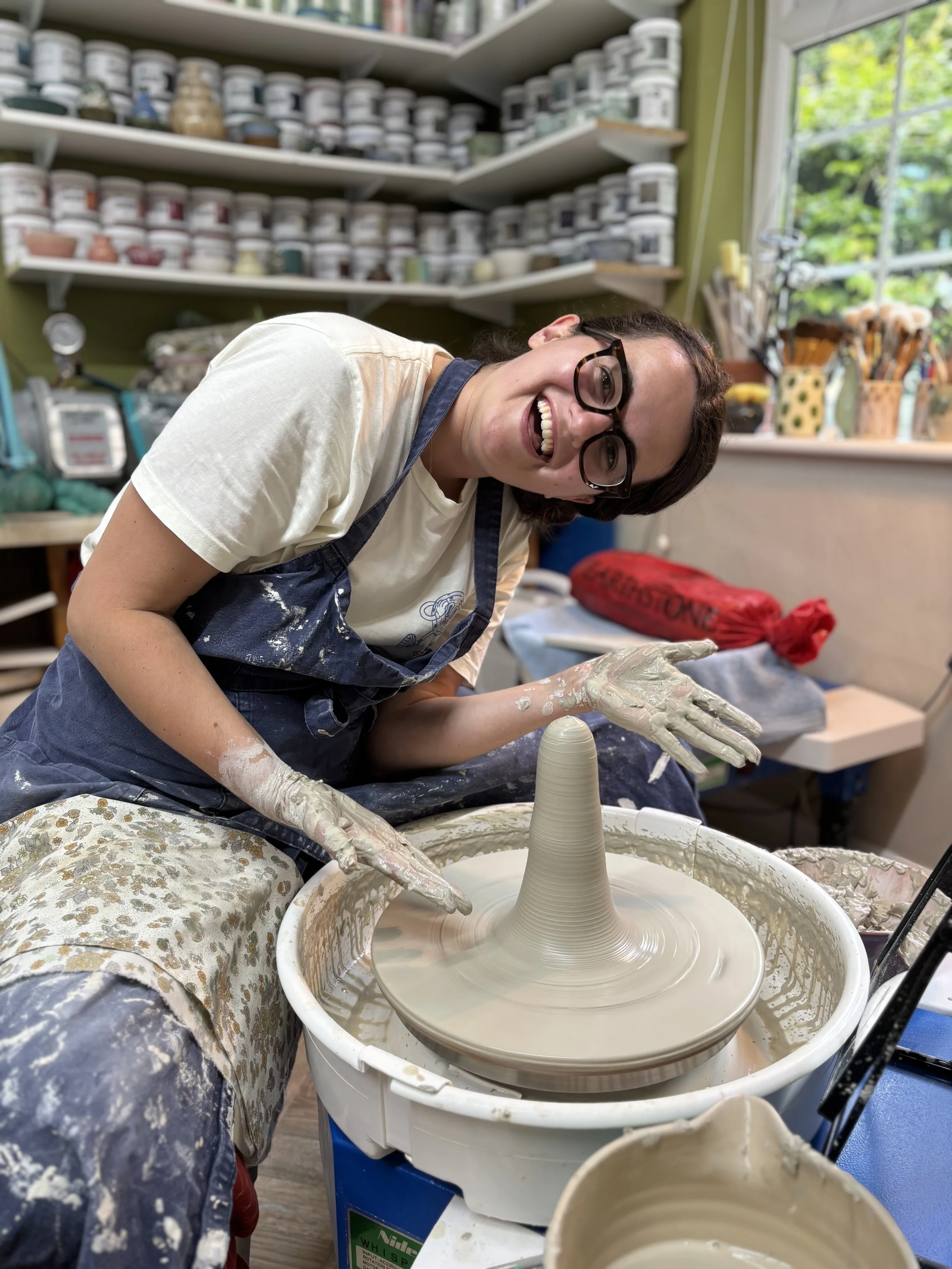   
 Lizzie has been getting to grips with centering larger balls of clay ... 
 