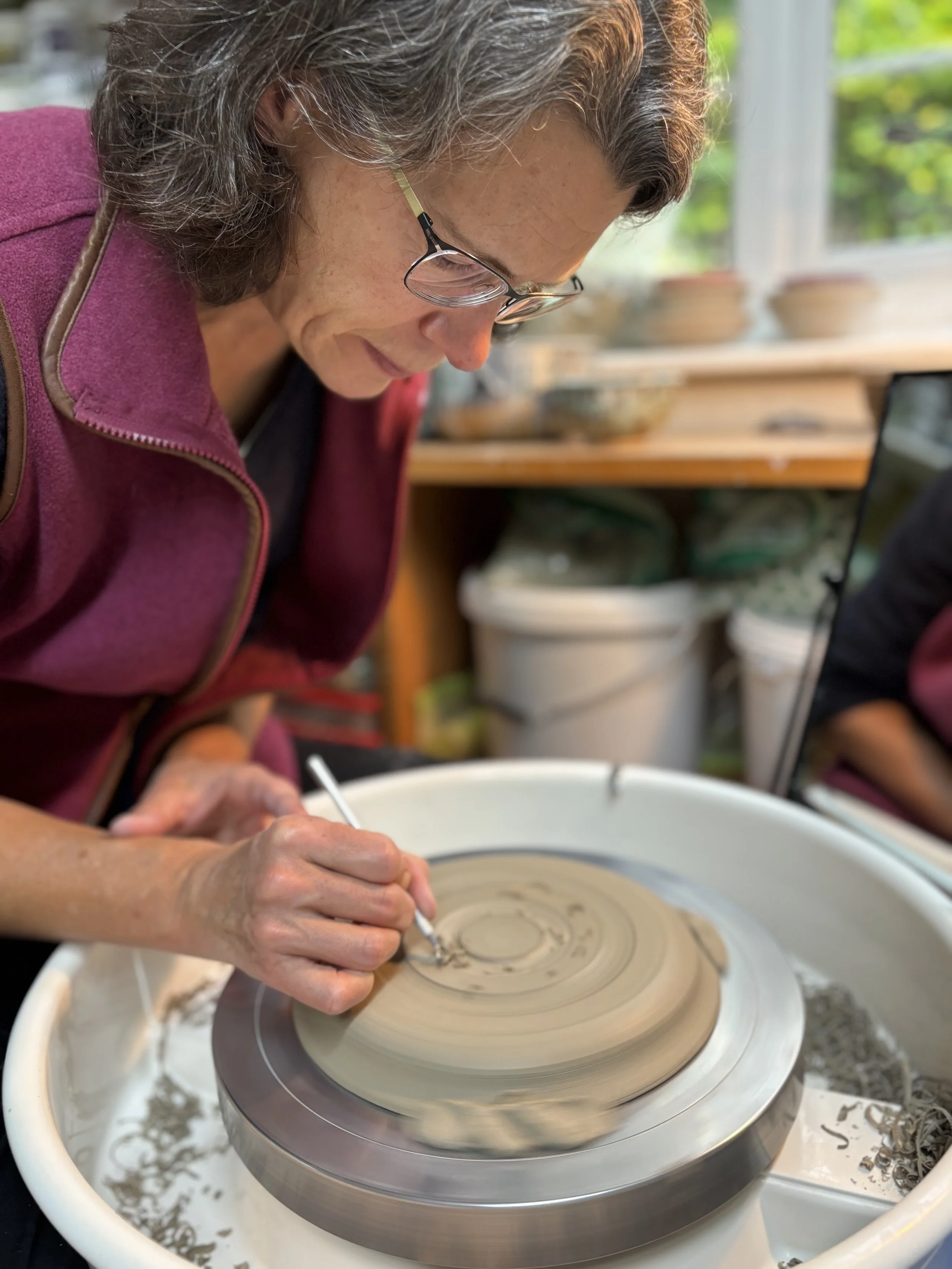 Elly has been trimming her latest pieces and choosing her glazing for her final session!