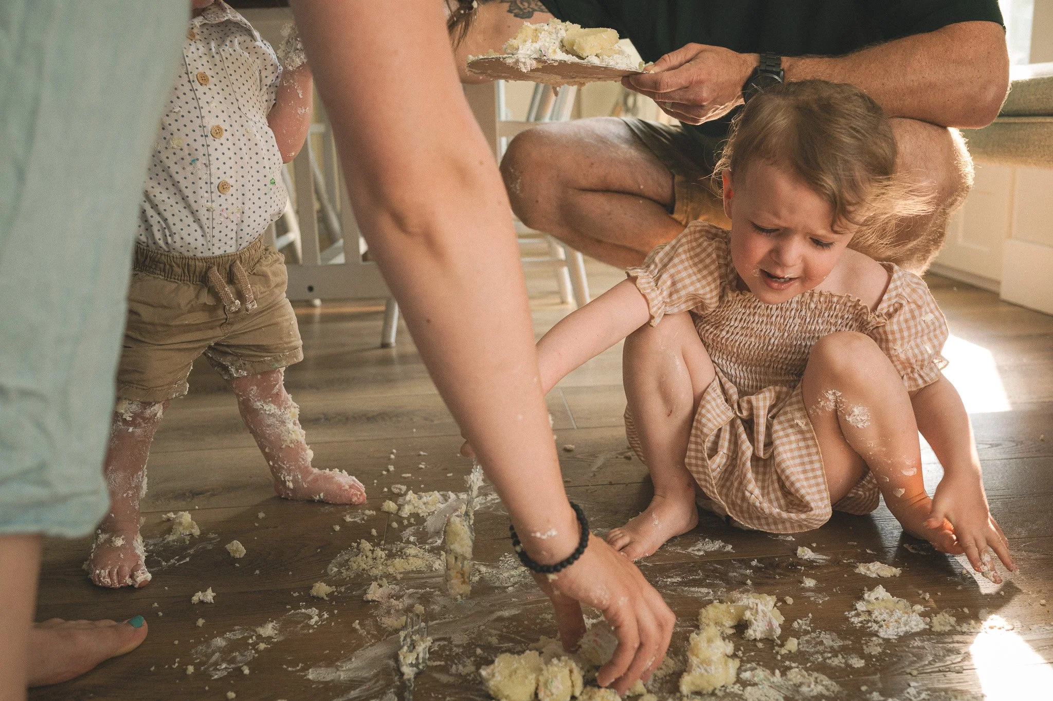 in home family photo session candid cake on floor