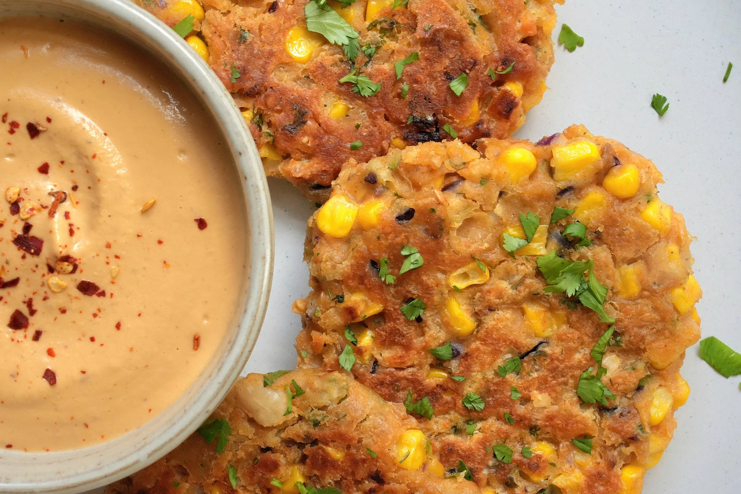 image of sweetcorn and white bean fritters with a chipotle cashew cream recipe