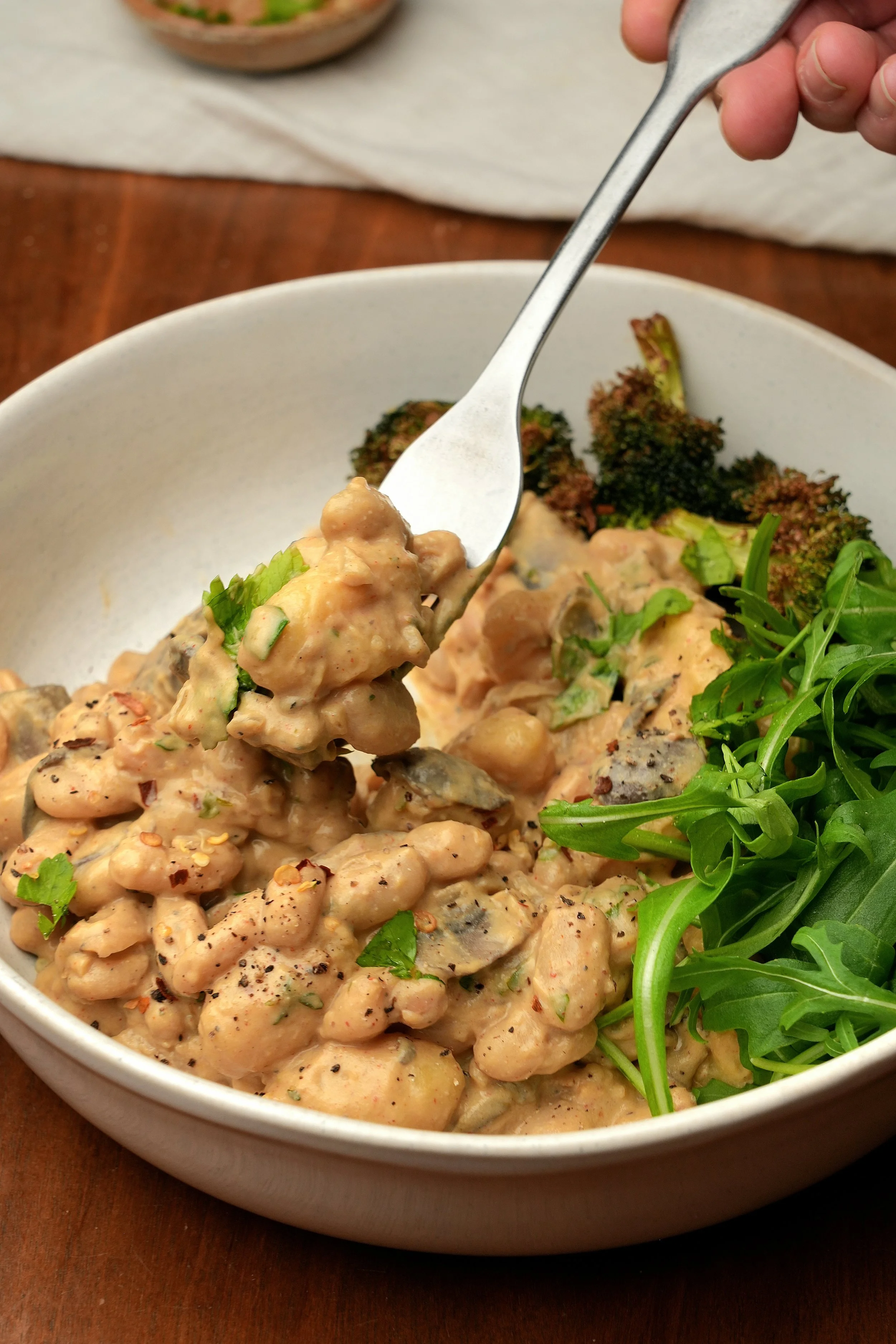 creamy miso mushroom cannellini beans with silken tofu high protein vegan batch cook meal prep image close up with gnocchi and veg