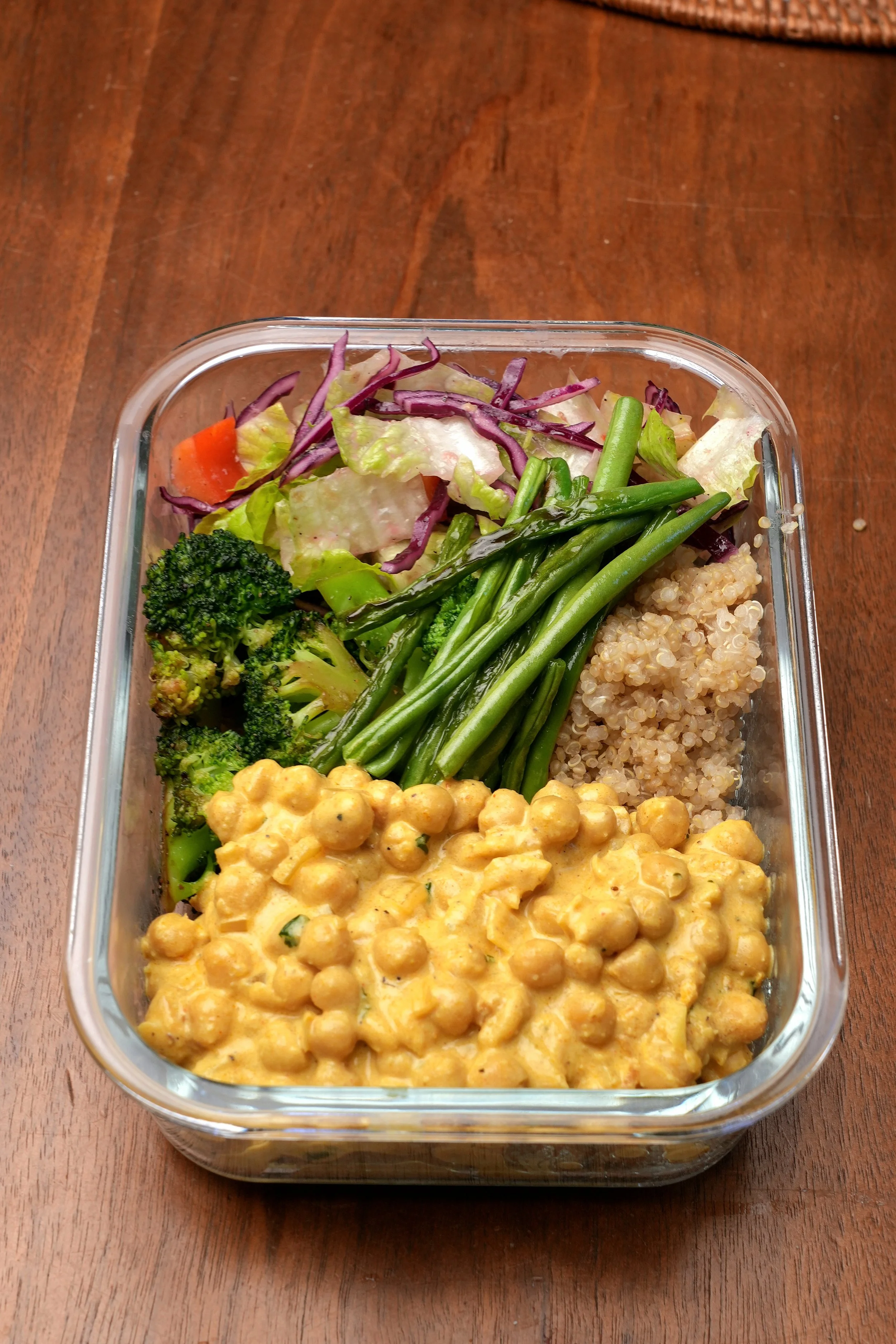 close up image of creamy high protein golden anti inflammatory chickpeas meal prep batch cook high plant protein high fibre turmeric ginger in packed lunch with salad