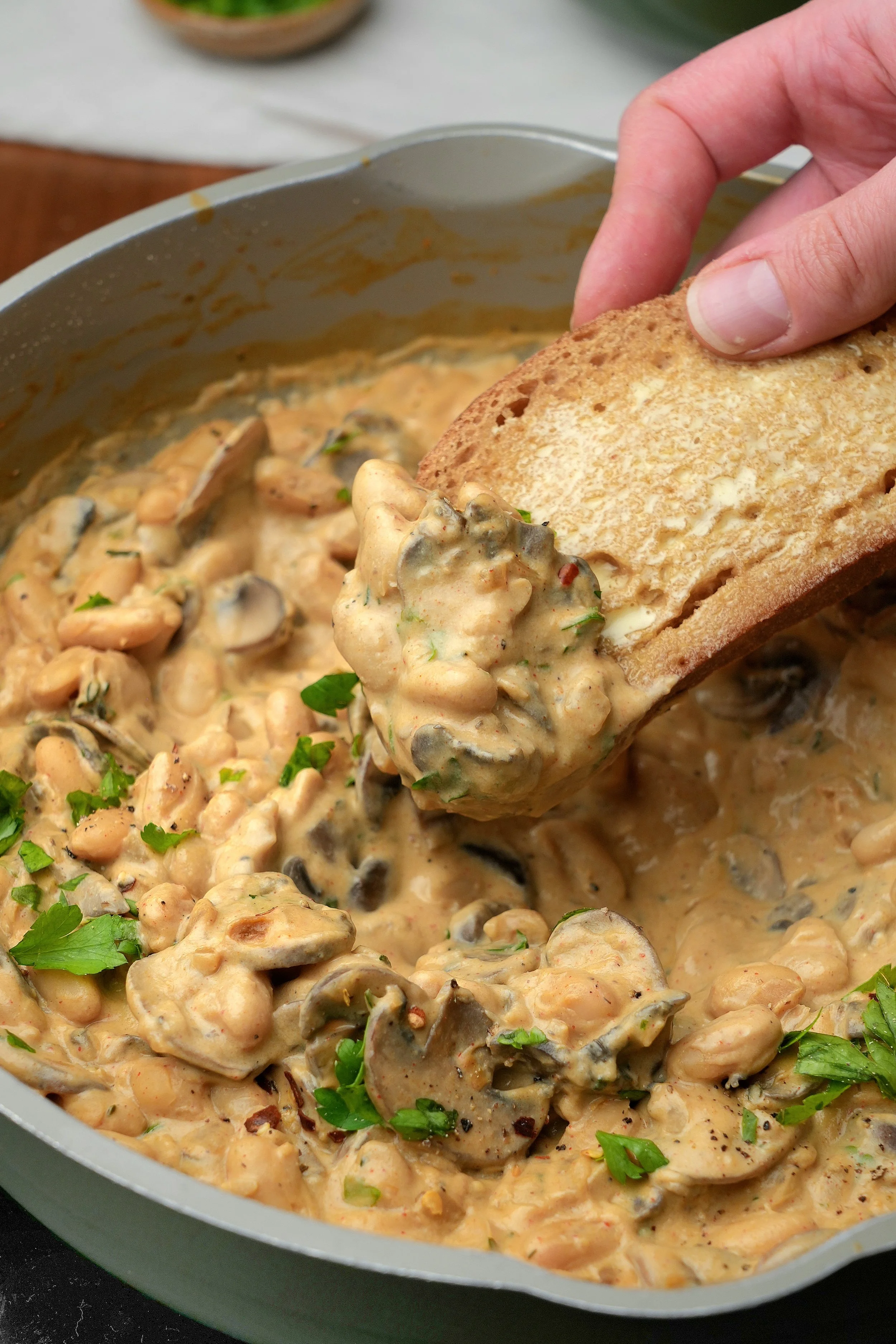 creamy miso mushroom cannellini beans with silken tofu high protein vegan batch cook meal prep image close up with toast
