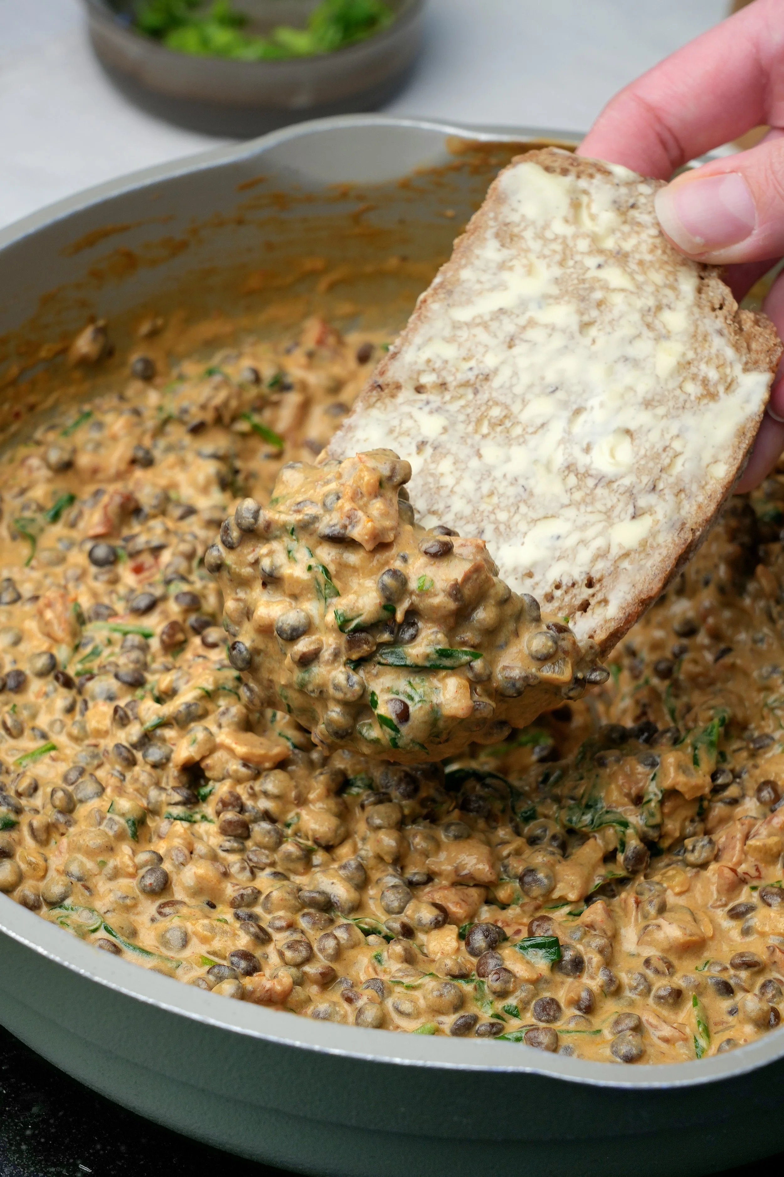 Image of marry me puy lentils with sundried tomatoes and spinach high protein high fibre vegan plant based batch cook meal prep friendly with toast