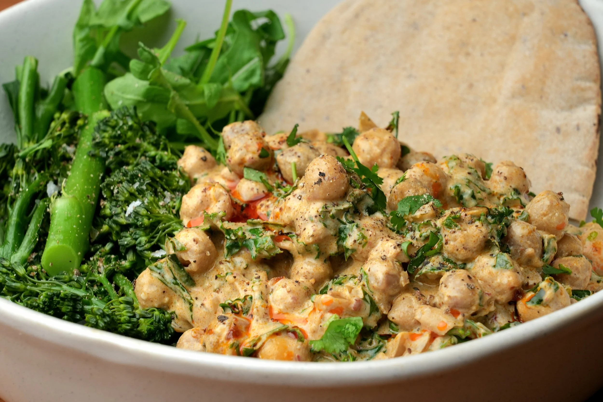 creamy high protein vegan harissa and kale batch cook creamy chickpeas meal prep friendly gluten free image with pitta bread and broccoli veg
