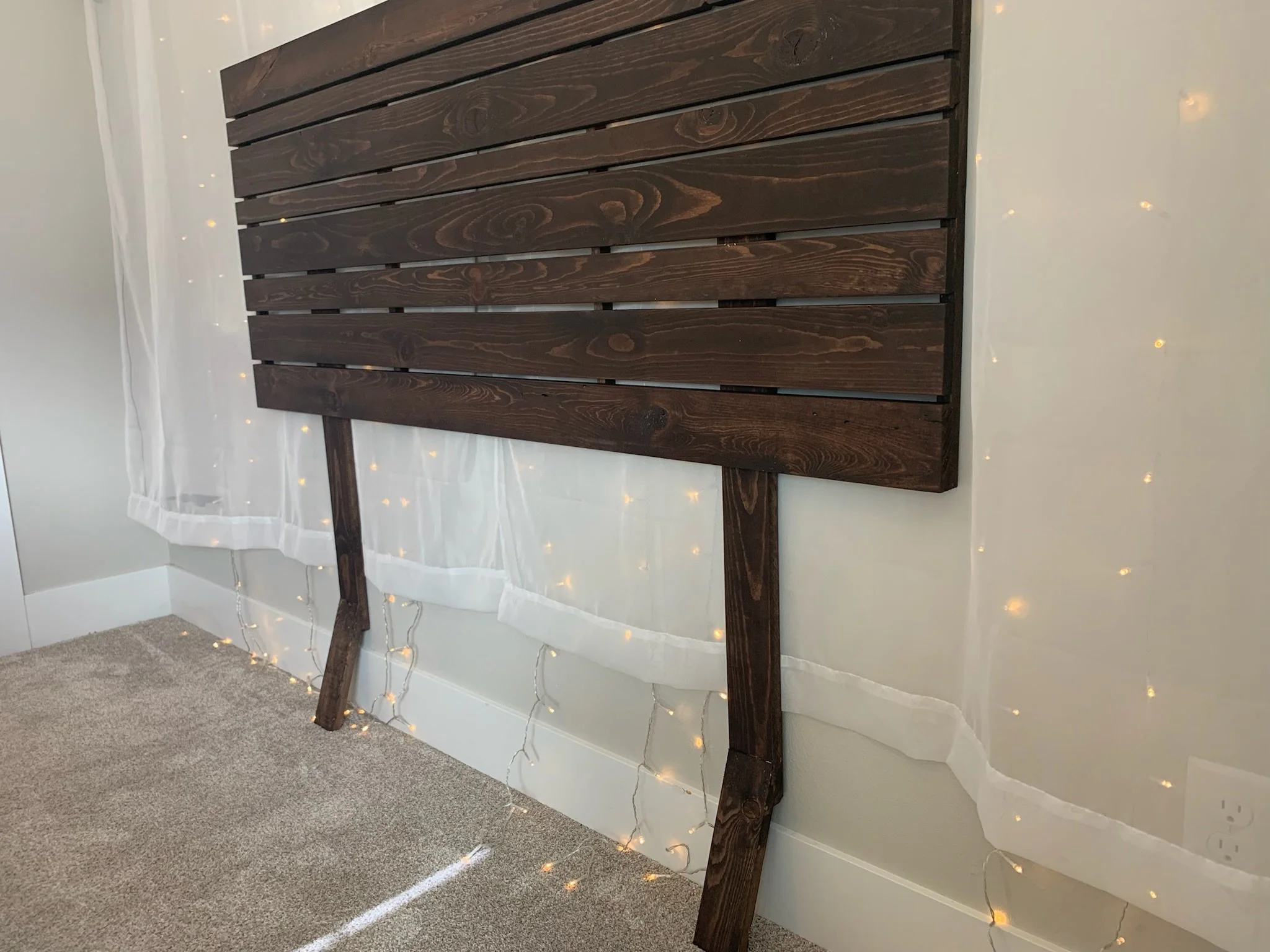 Angled lower legs hold headboard securely against the wall and miss the baseboard