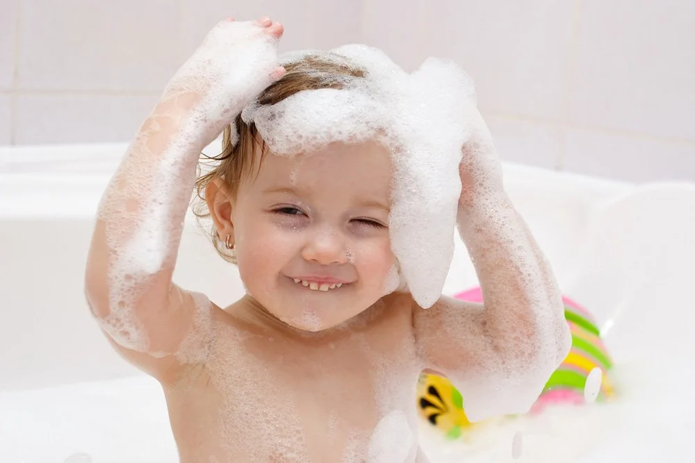 kid enjoying warm bubble bath
