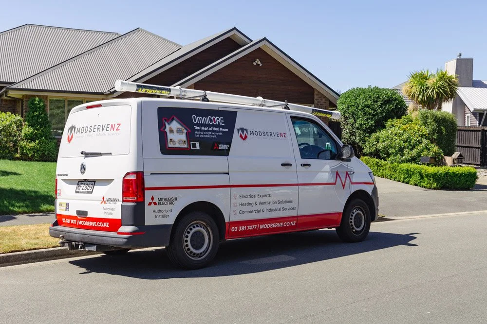 modserve branded vehicle parked in front of house