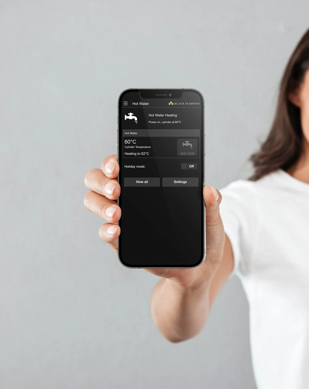 hand holding aquacore hot water heat pump app on mobile phone