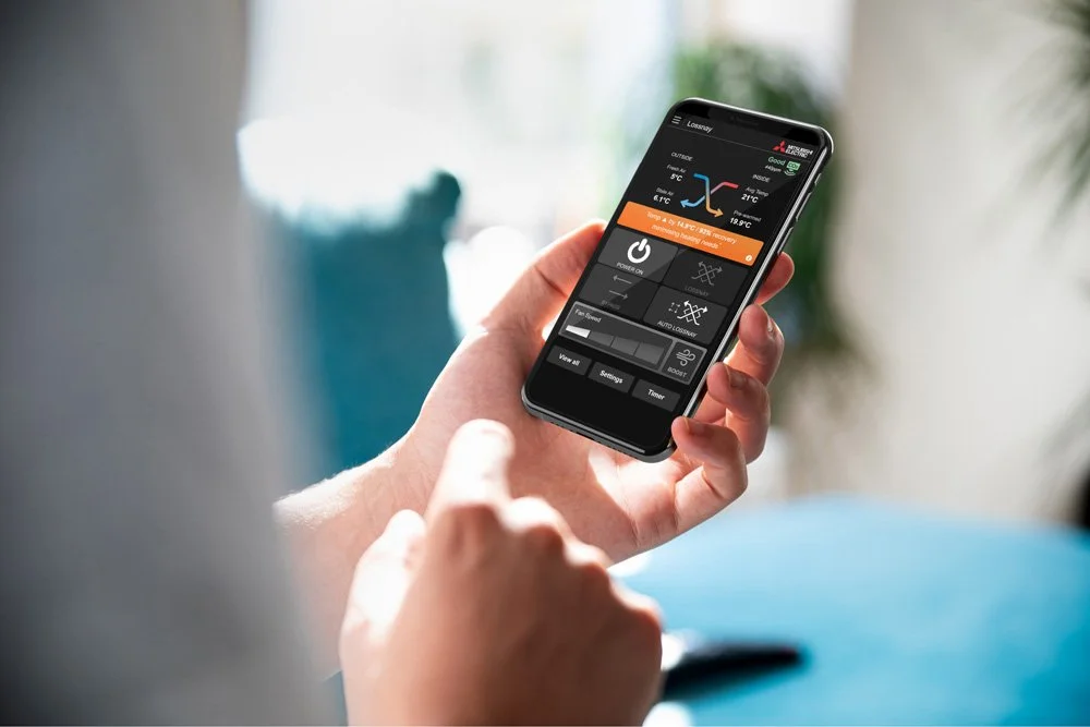 close up of hand holding phone showing lossnay ventilation system controls via wifi