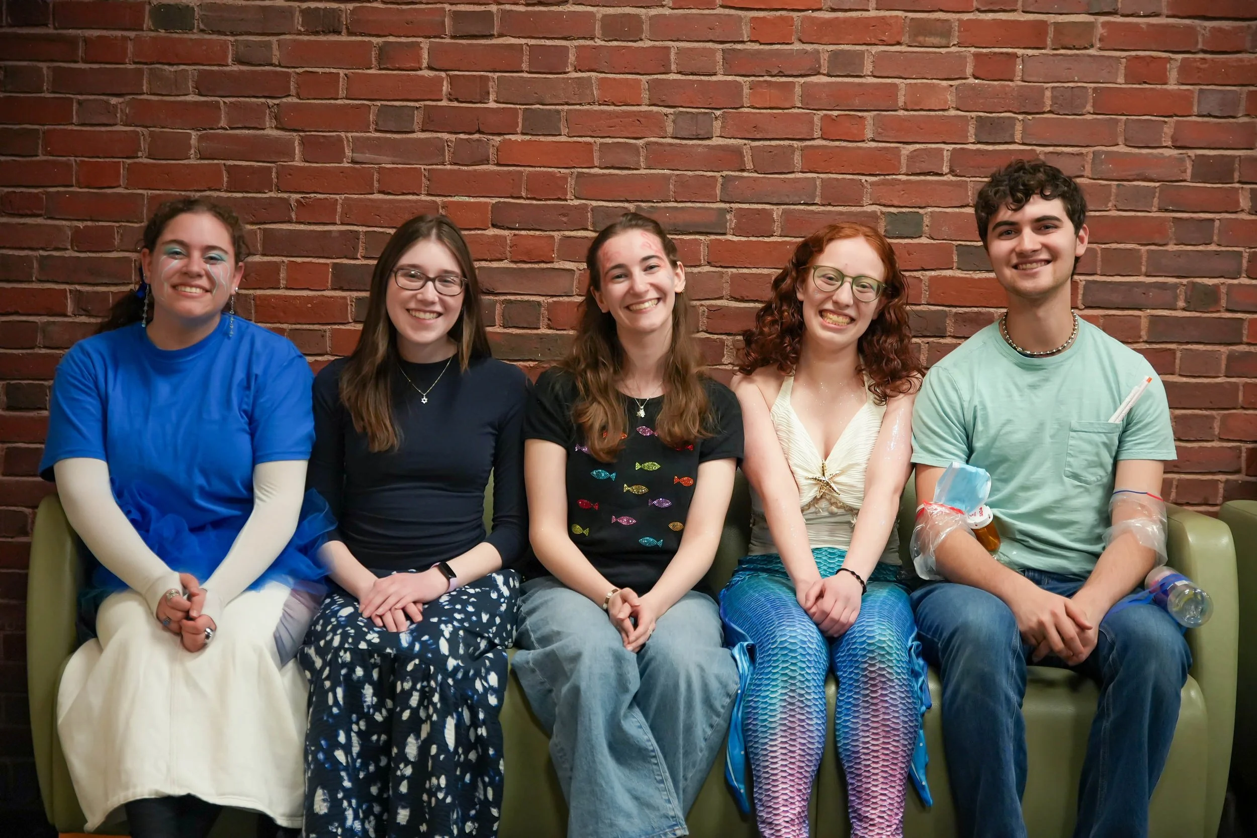 Students sitting on a couch, smiling