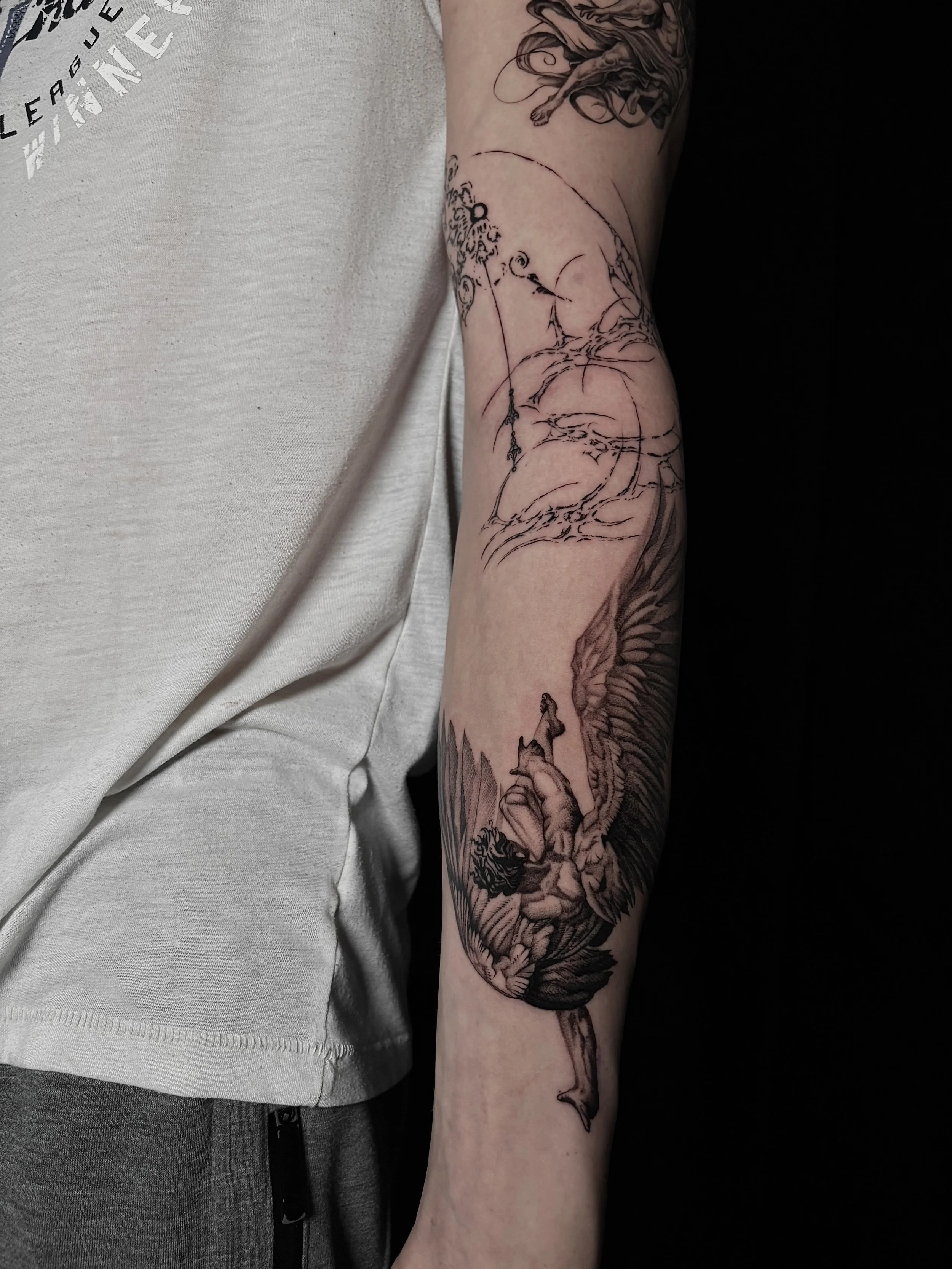 Black and gray tattoo of Icarus falling, Surrealism Tattoo Done by Pablo at Ink Terminal Ottawa Gatineau