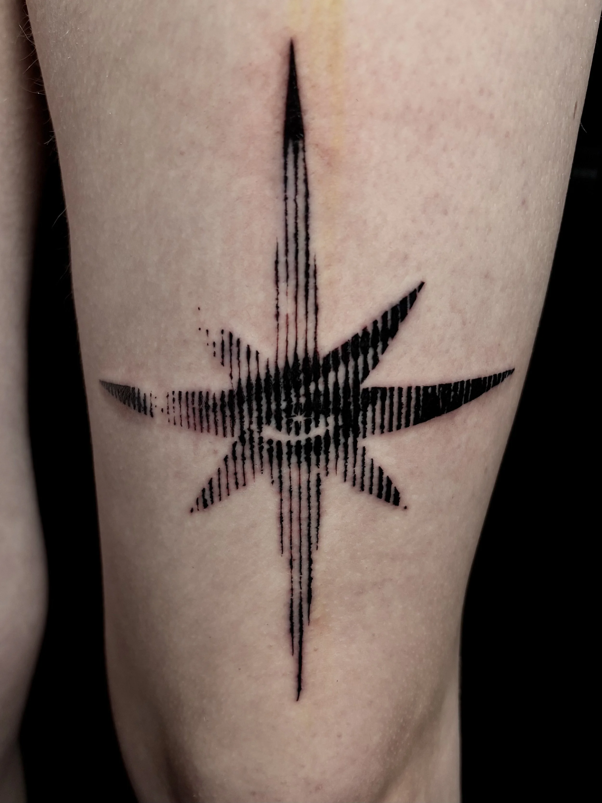 Close-up of a tattoo of a Star with an eye staring out Surrealism Tattoo Done by Pablo at Ink Terminal Ottawa Gatineau