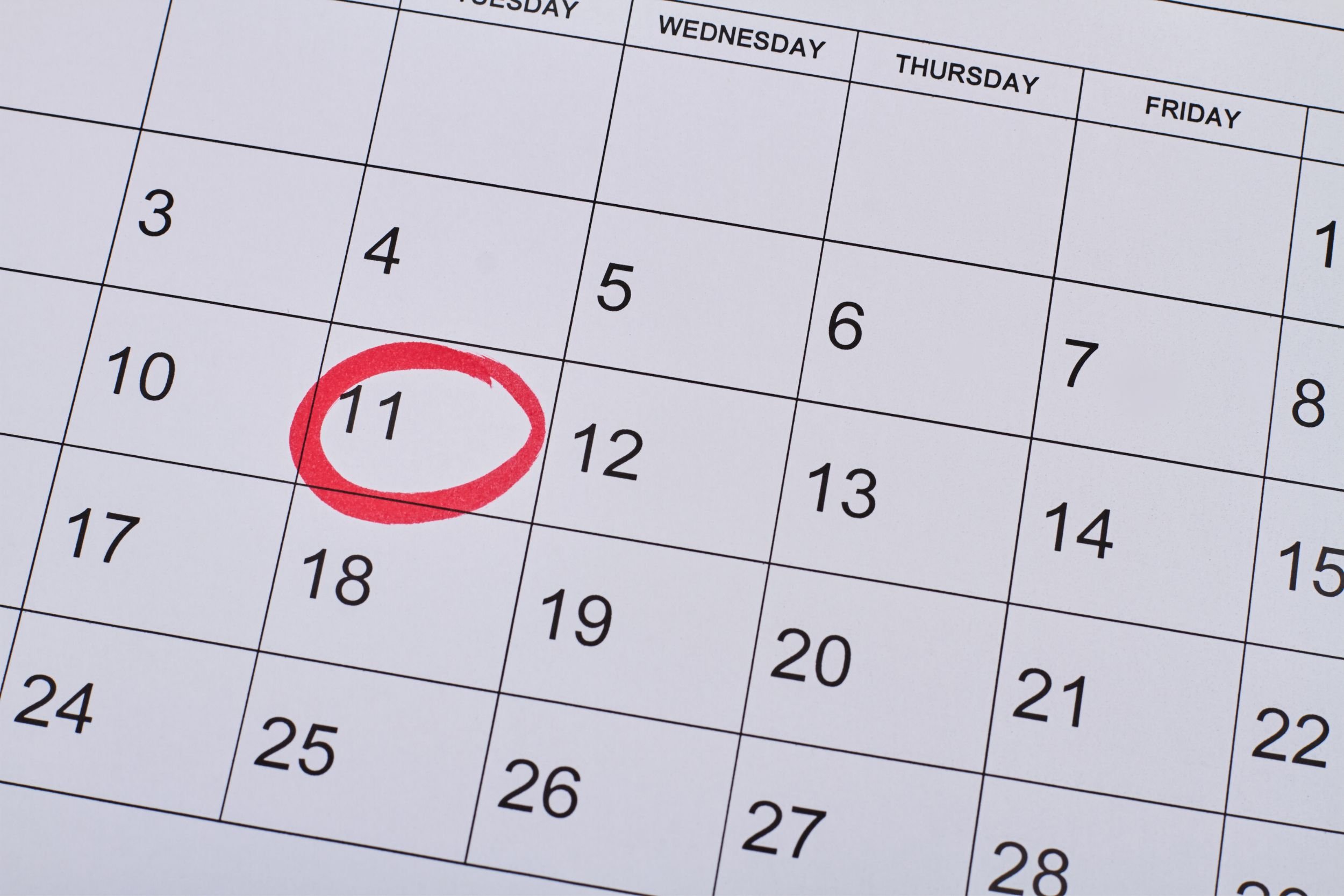 A white calendar with the date of the 11th circled in red.