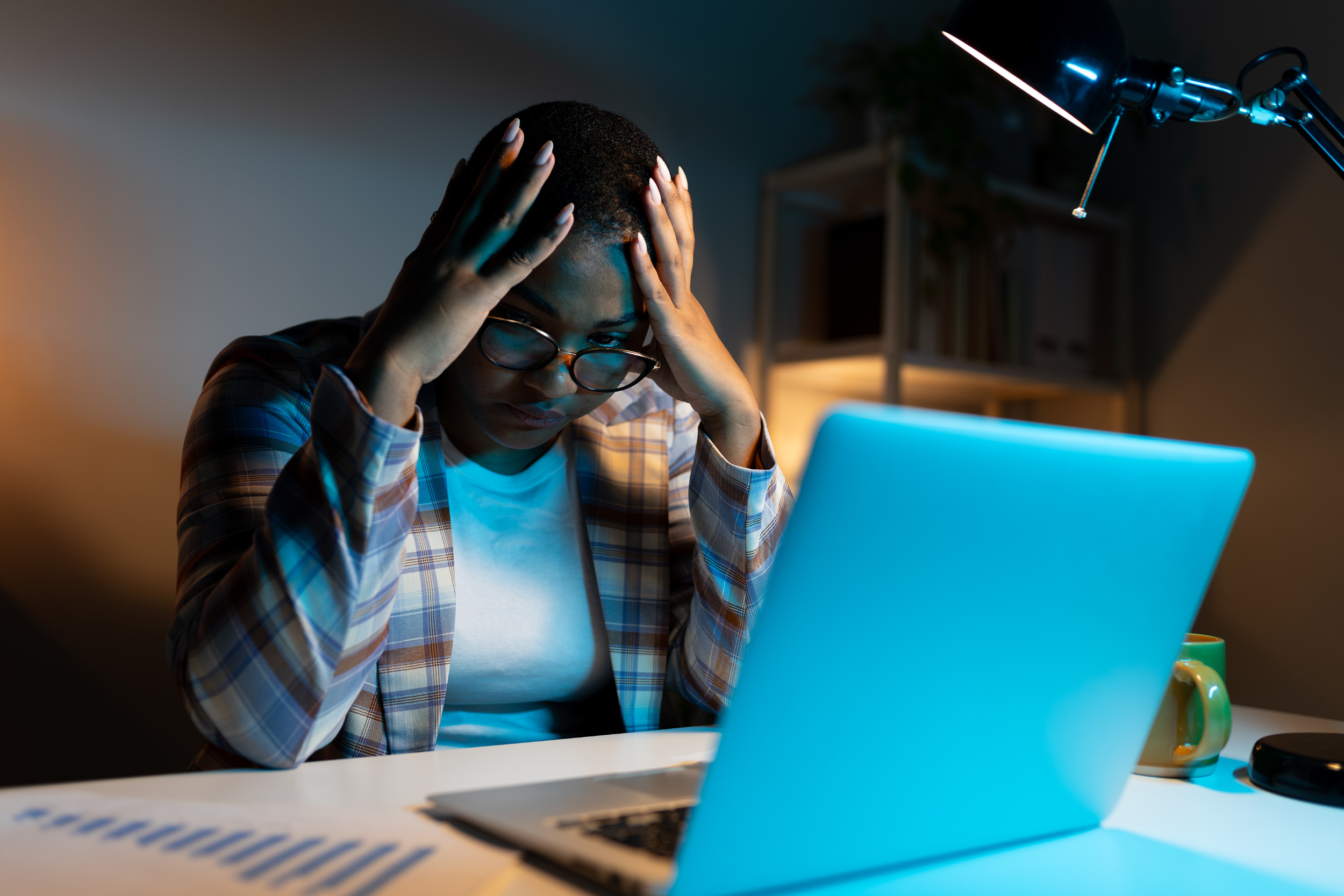 International student reviewing results on a laptop and looking stressed.