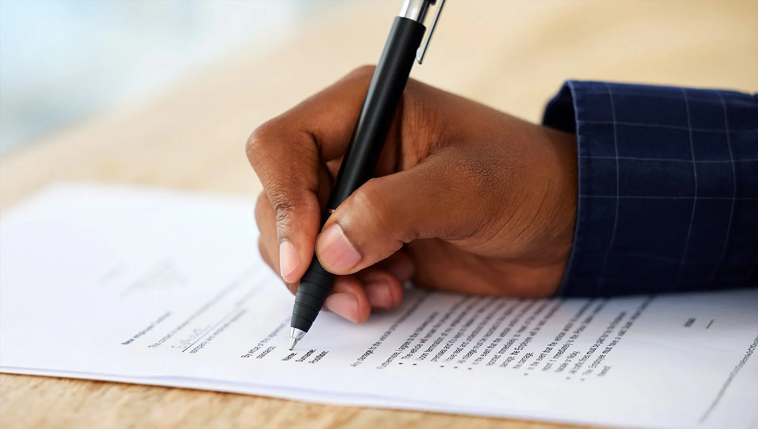Man completing a LMIA form