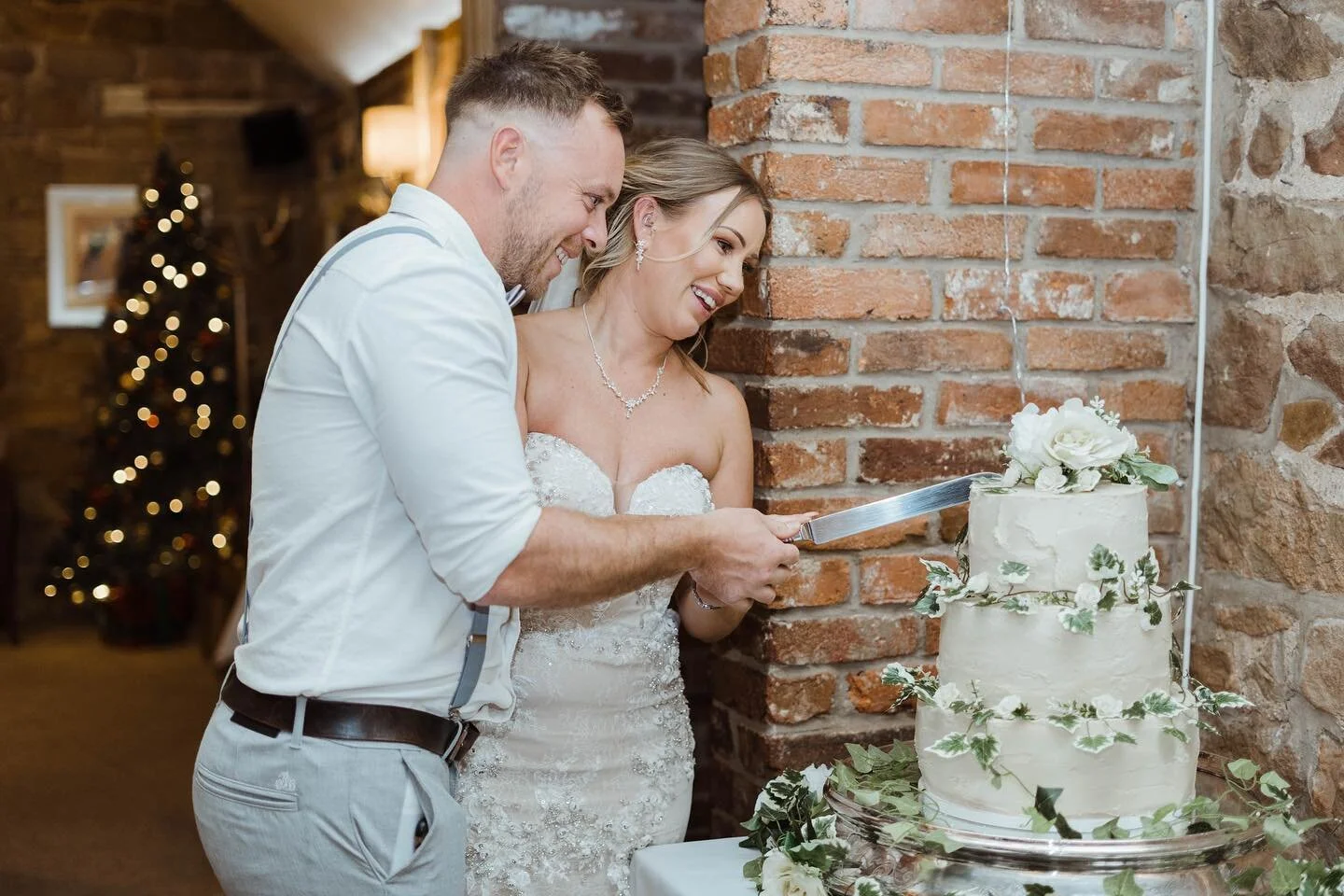 The wonderful Jodie and Ste cutting their amazing cake! 
I love the Christmas tree in the background of this one, but I am really looking forward to spring season starting soon!
