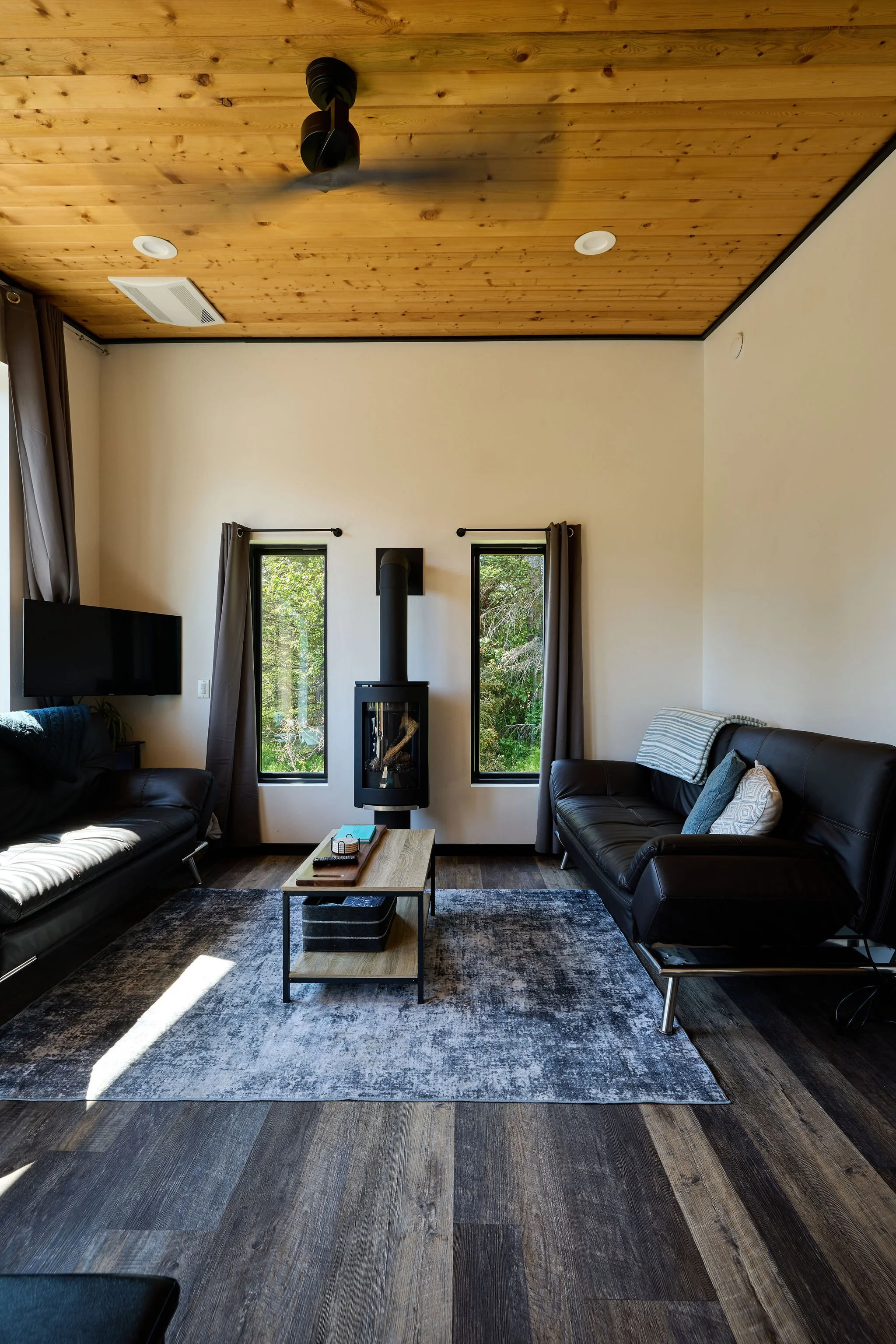 The living area includes two futon couches