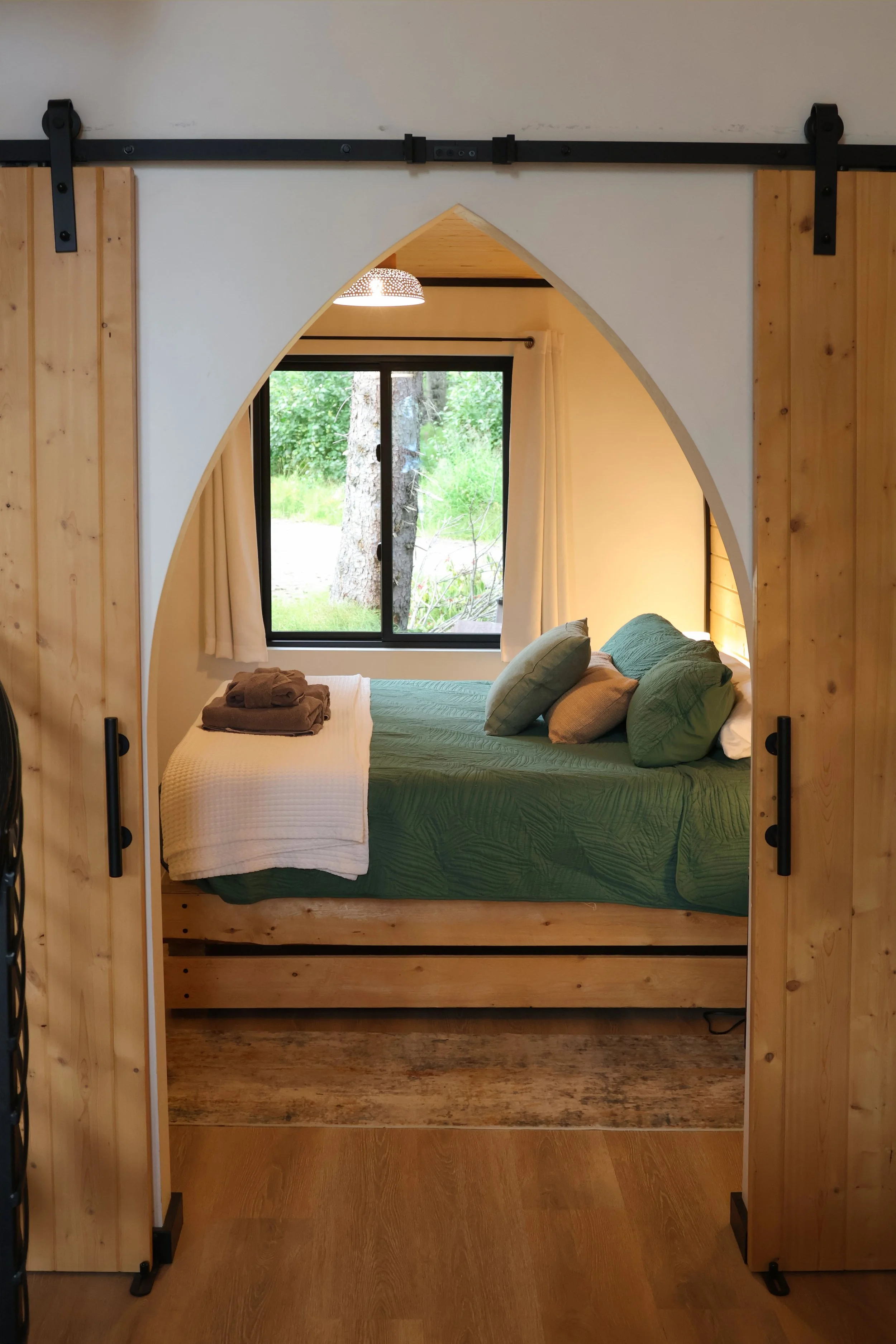Main floor bedroom with a king bed and sliding doors for privacy