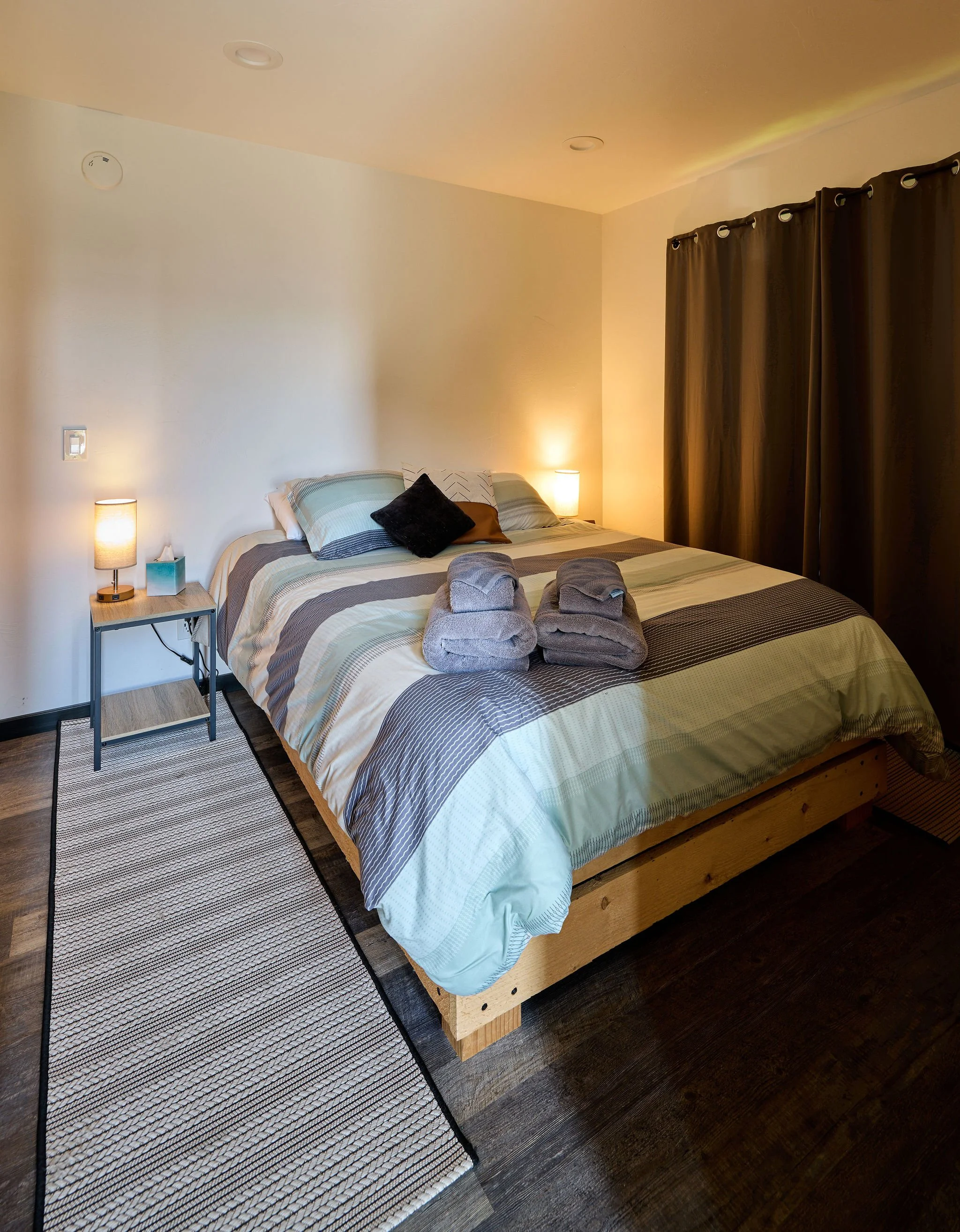 Large king sized bed in downstairs bedroom with closet storage 