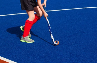 girl-playing-field-hockey-on-260nw-625039820.png