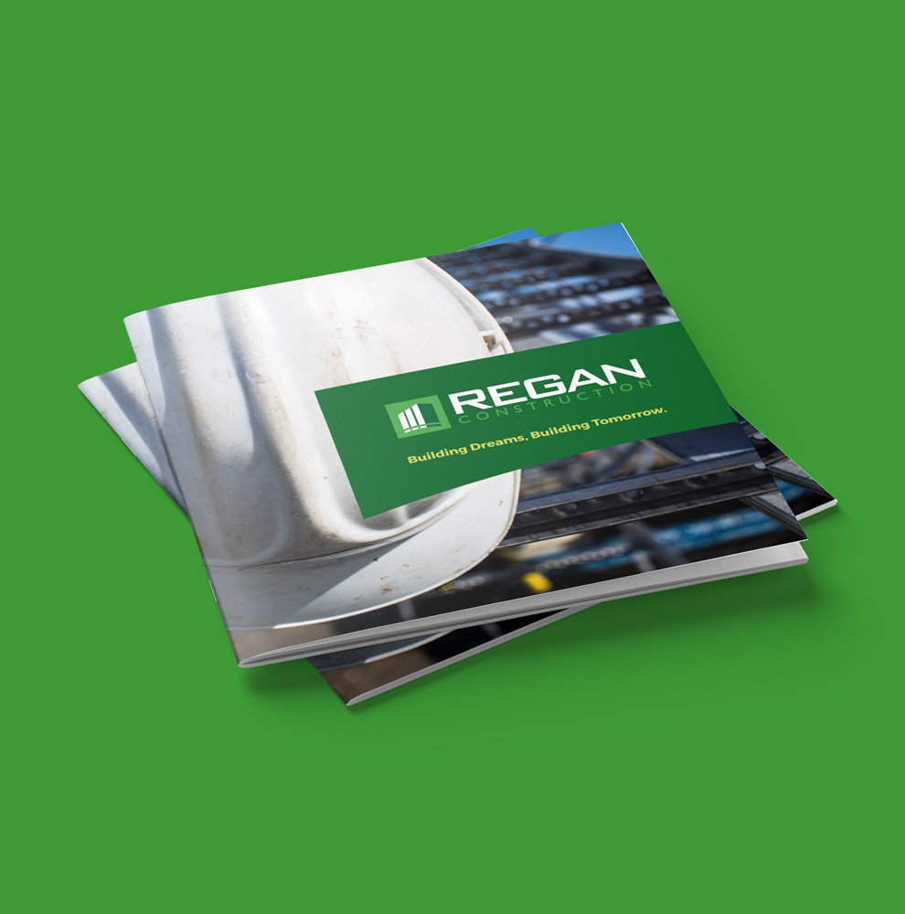 Regan Construction brochure cover design showing logo, Tagline and striking hard hat image.