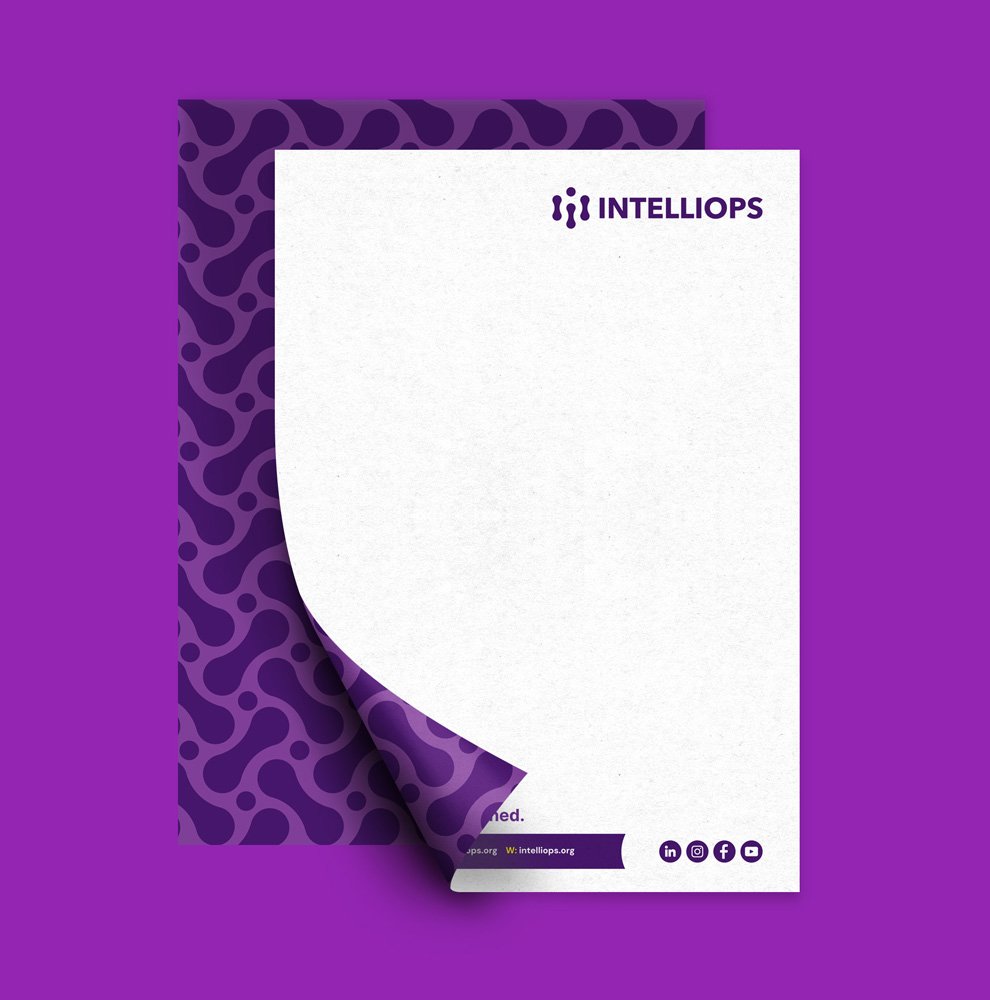 IntelliOps branded stationery design with purple pattern and logo placement