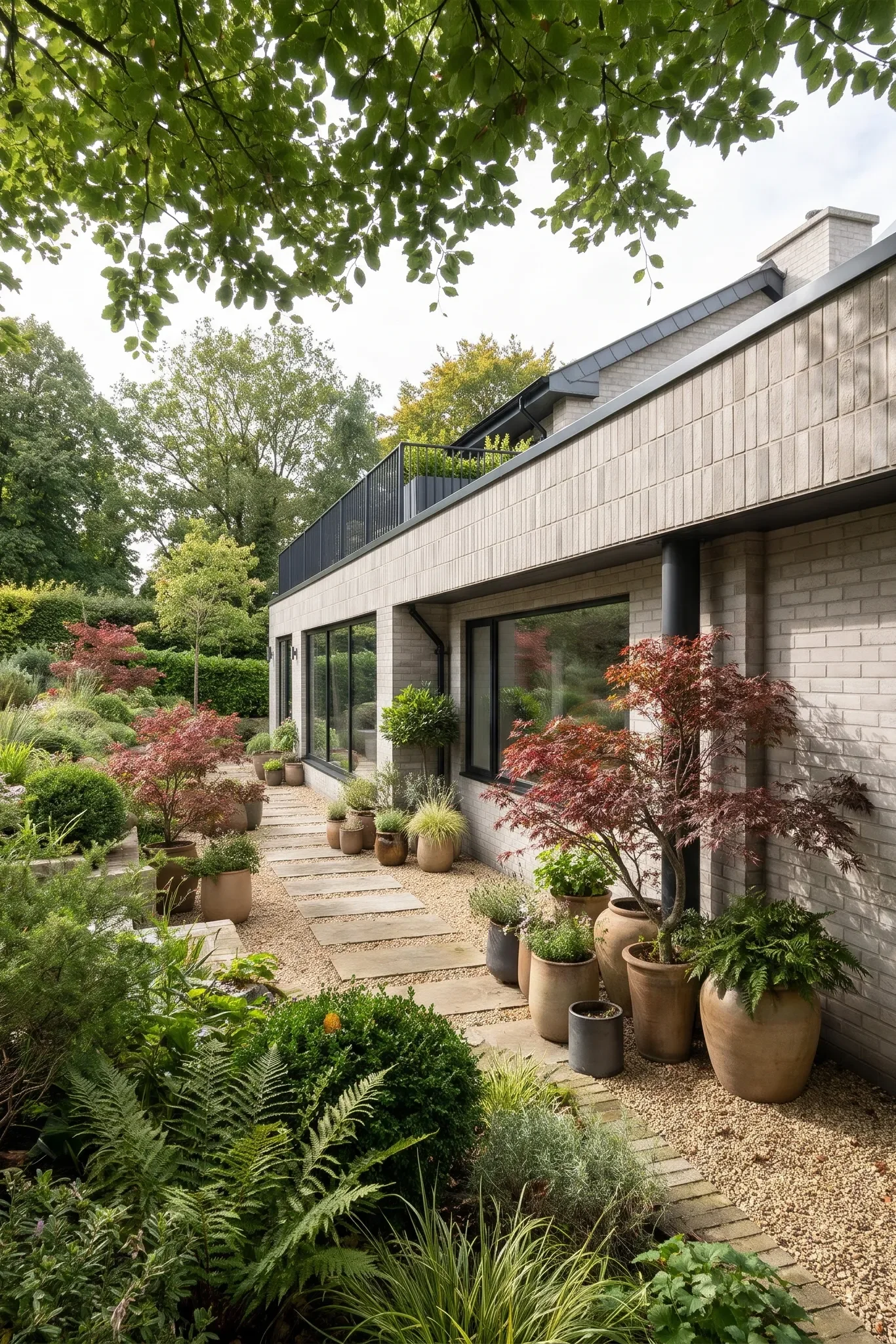 A planted terrace creates a sheltered route alongside the house