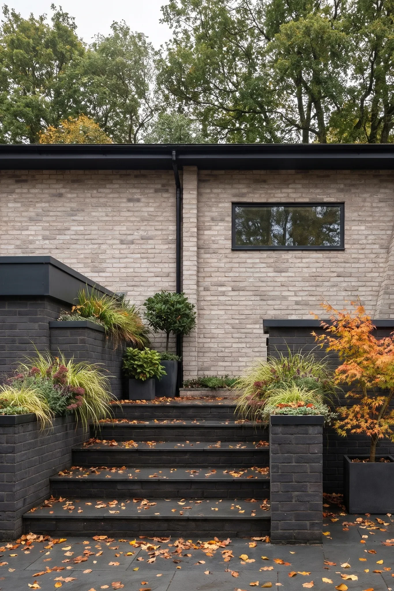 Dark brick planters frame the steps to the entrance