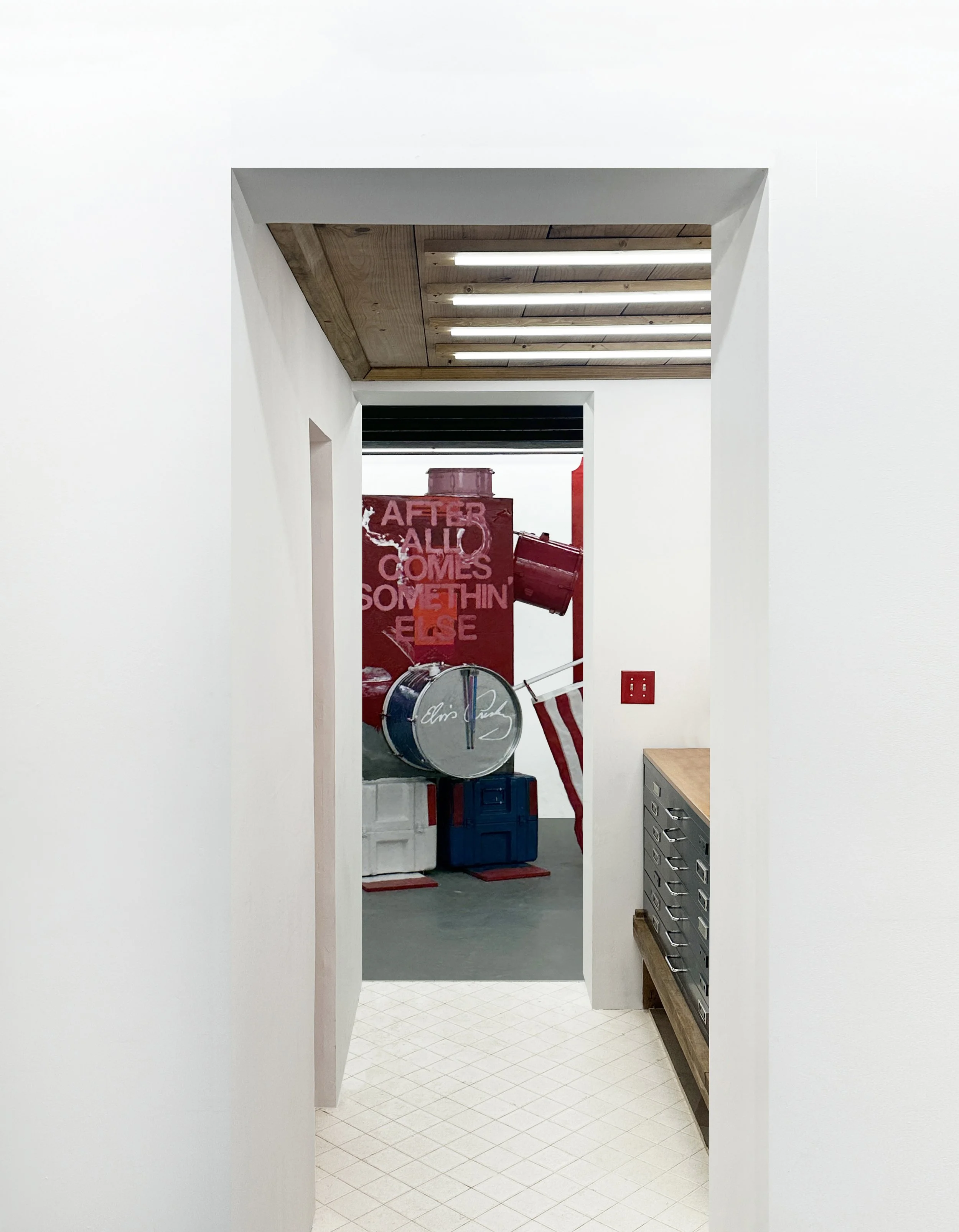 White hallway leading to a space with American flag-themed artwork and red, white, and blue decorations.