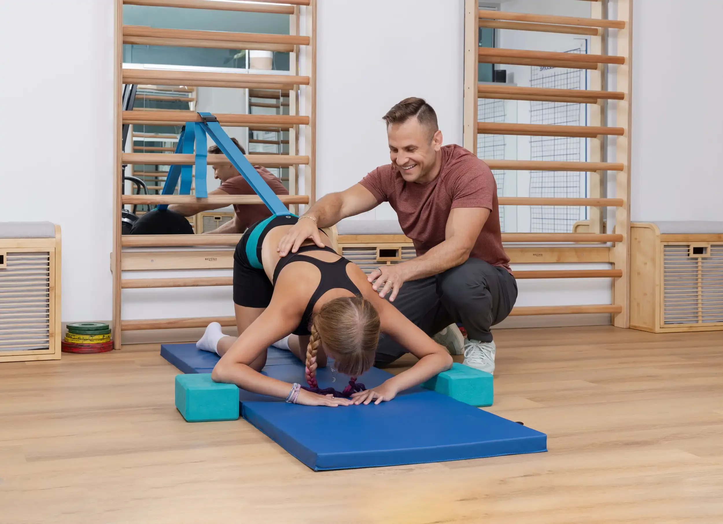 physical therapist guiding a teenage patient in a Schroth exercise