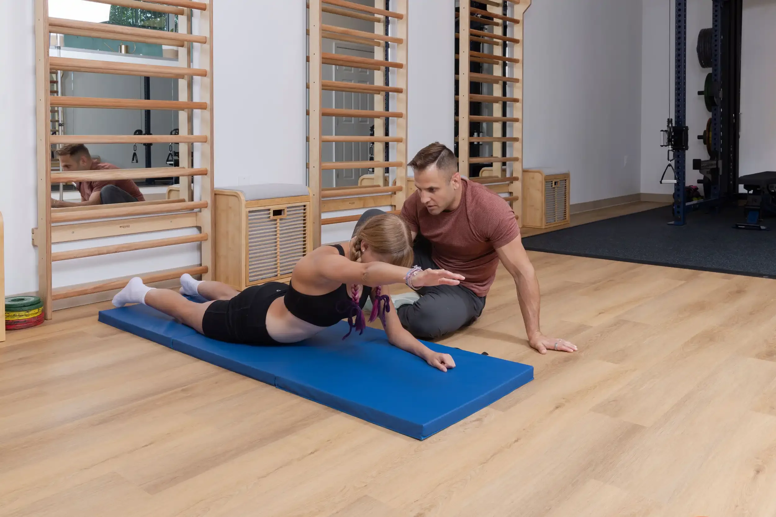 physical therapist guiding a teenage patient in a Schroth exercise