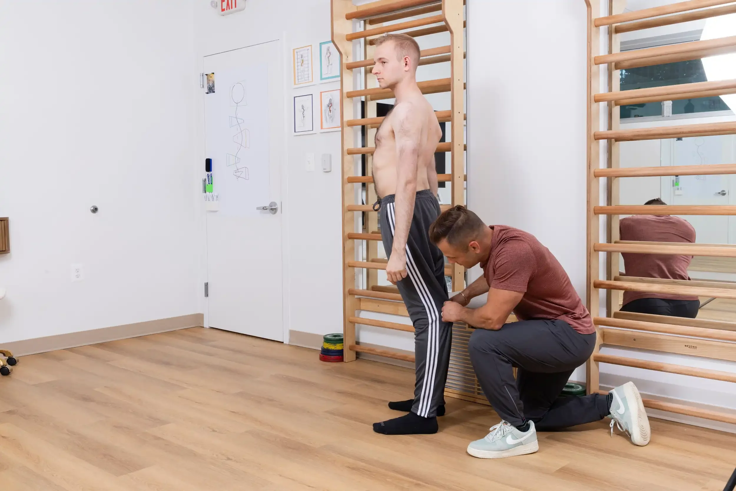 physical therapist showing hypermobility of the legs on an adult patient