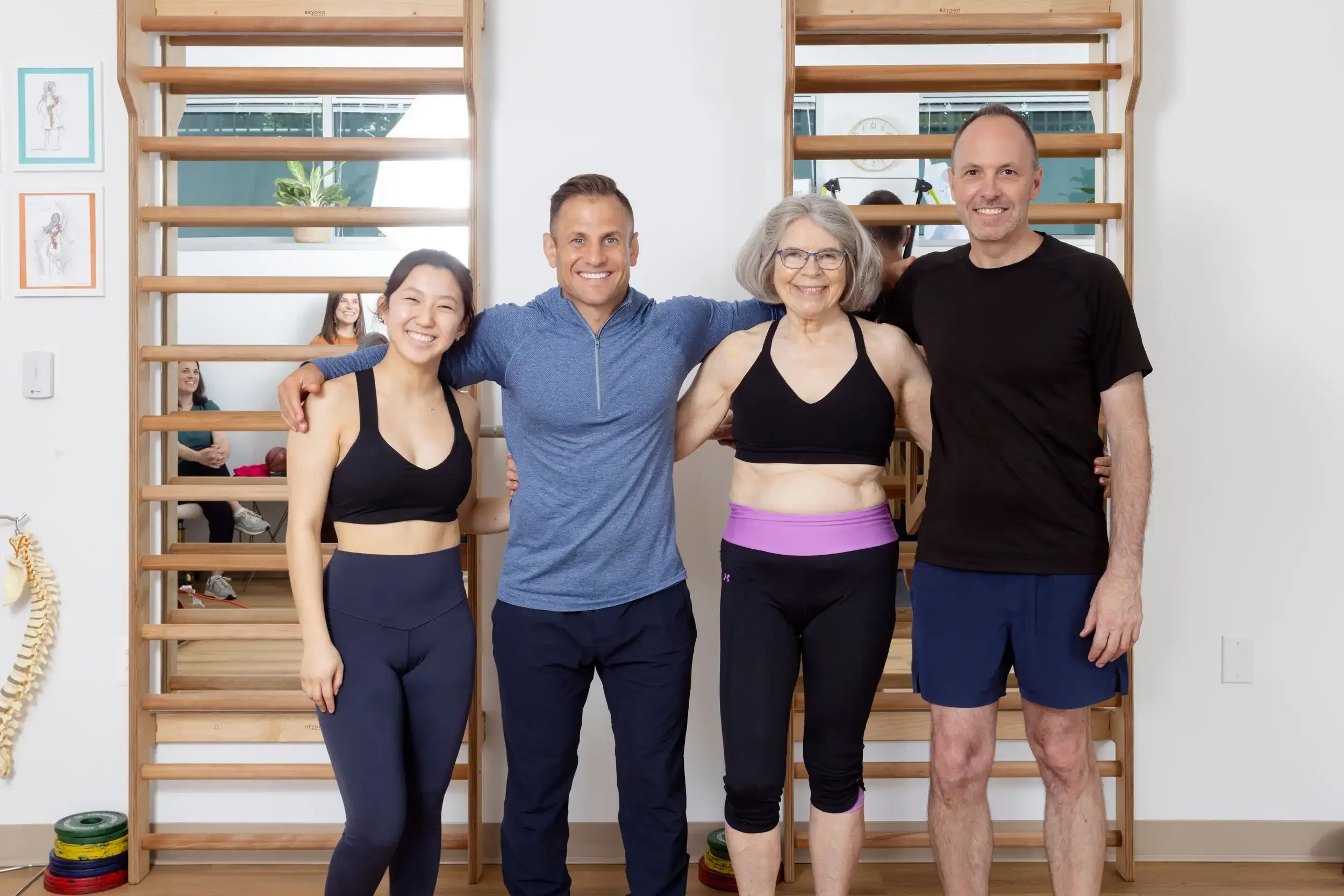 physical therapist with three students in small group class