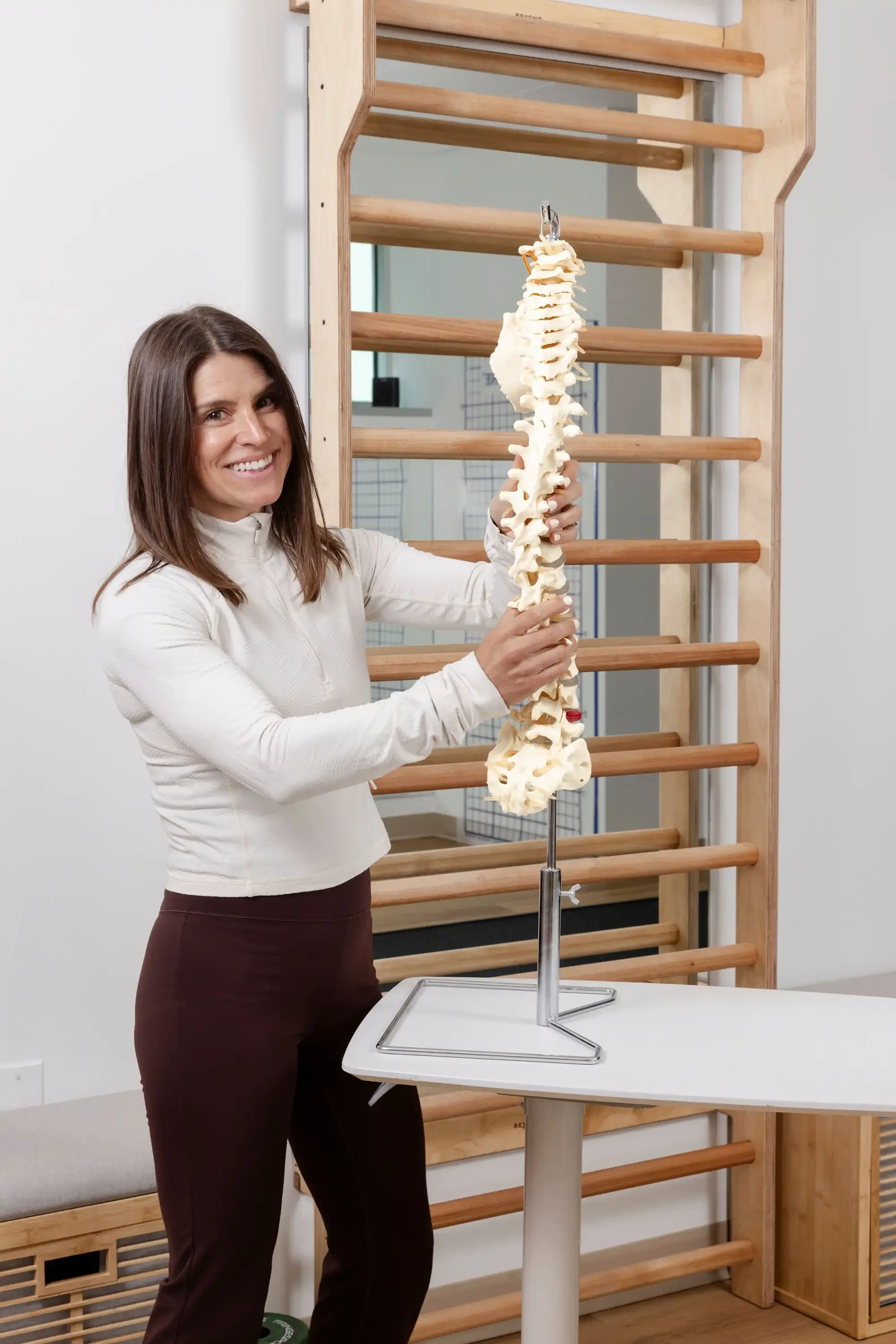 scoliosis specialist holding a human spine model