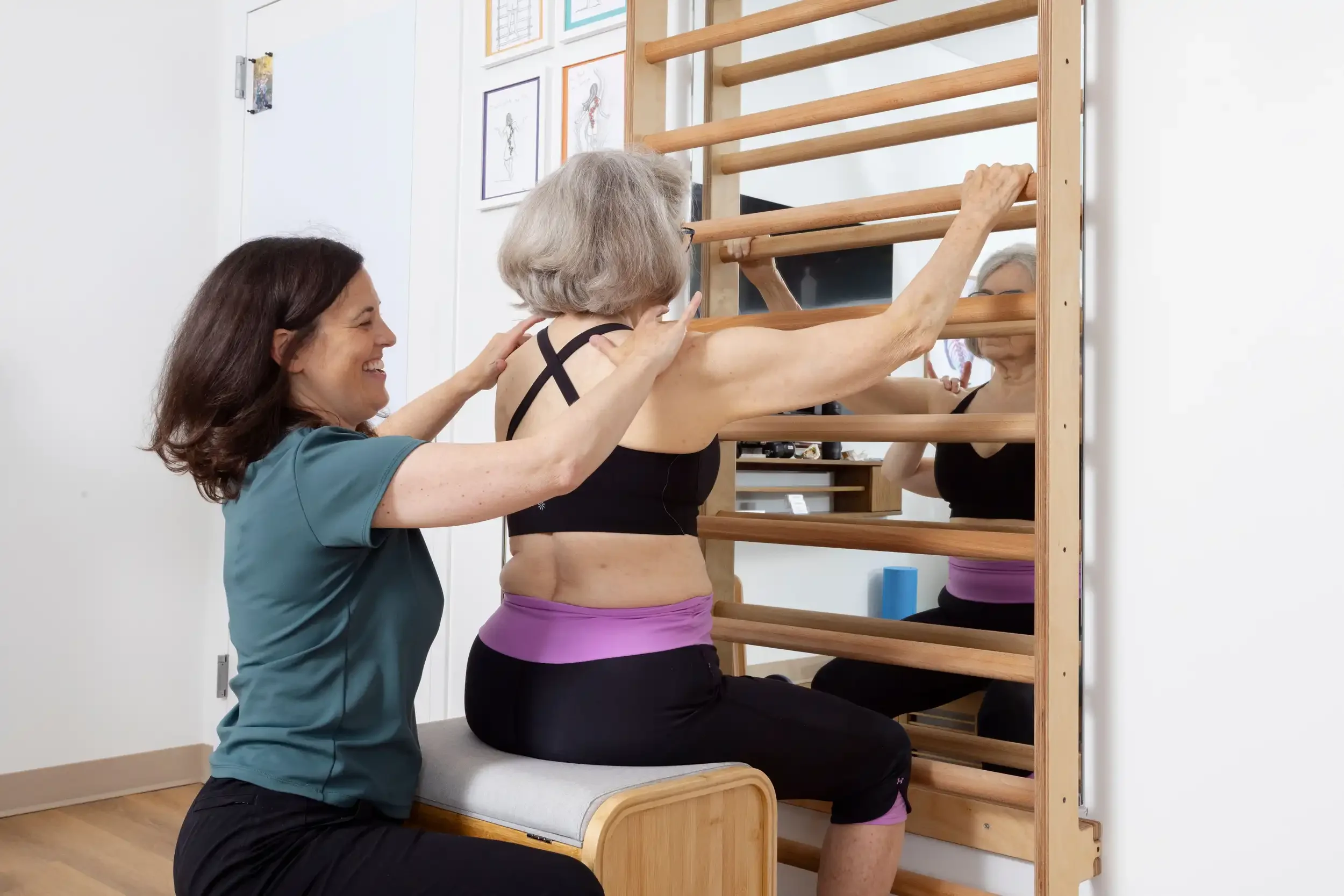 physical therapist guiding a senior patient in a Schroth exercise