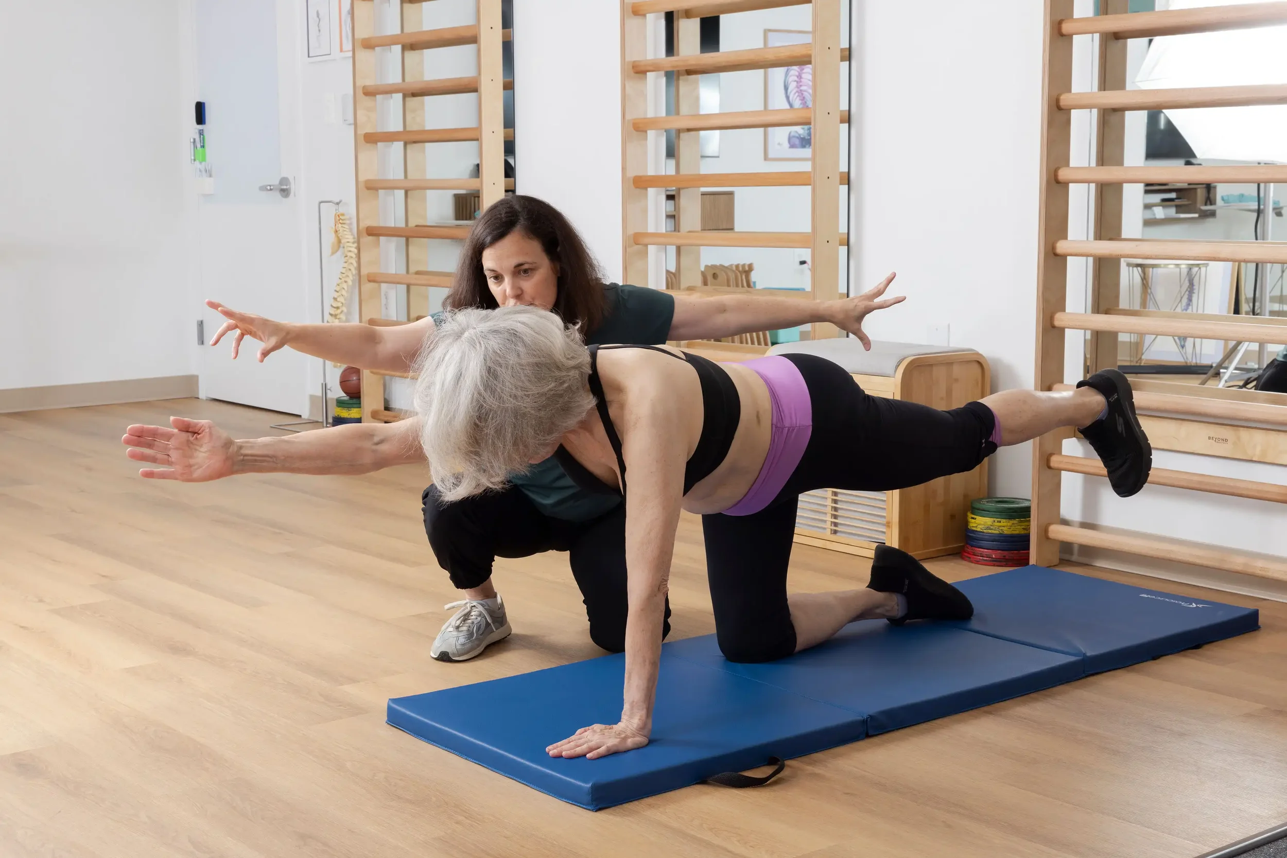 physical therapist guiding a senior patient with Schroth exercise