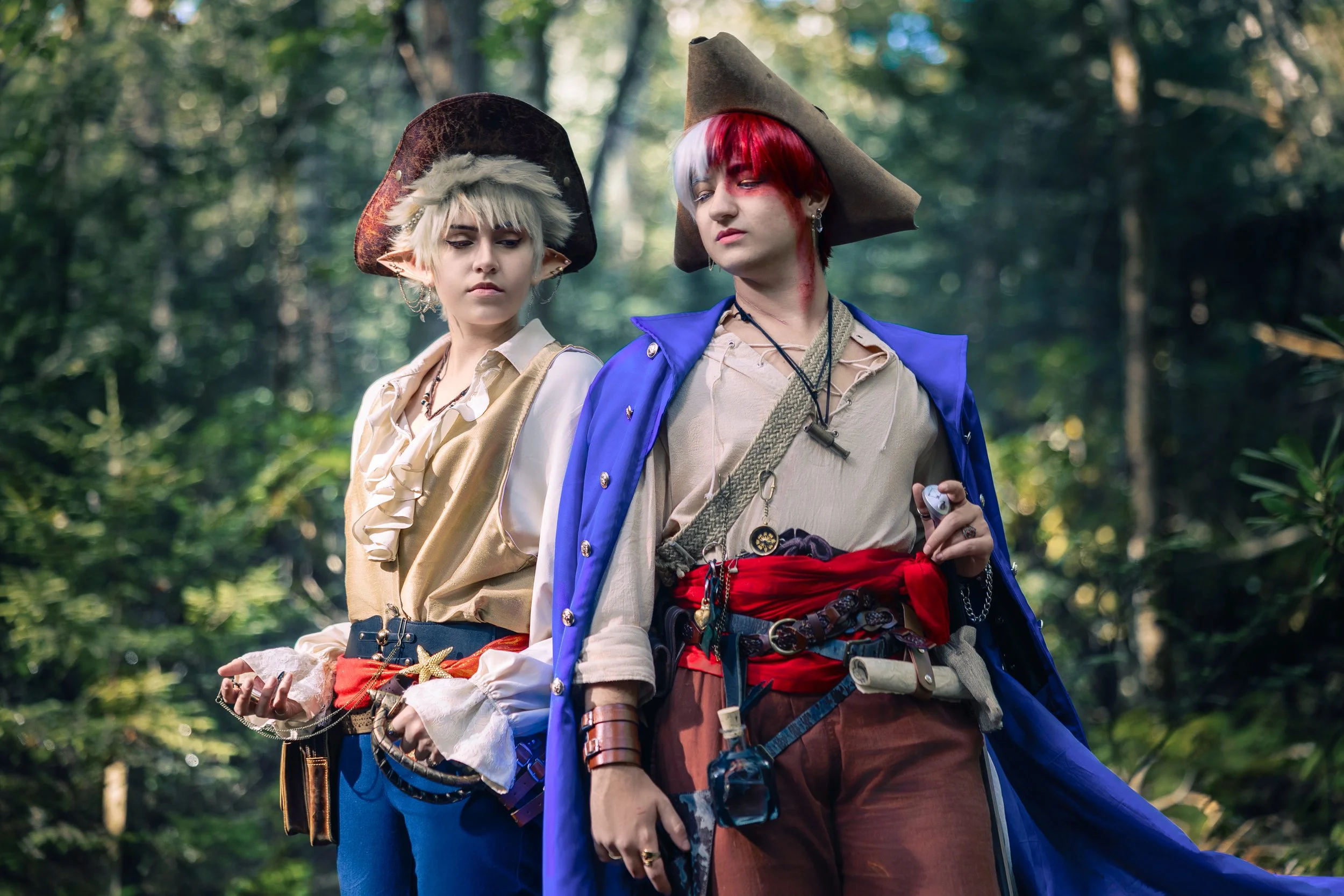 2 cosplayers, cosplaying Todoroki and Bakugo from My Hero Academia, stand together for a photo. Their cosplays are part of a Pirate AU (alternative Universe).