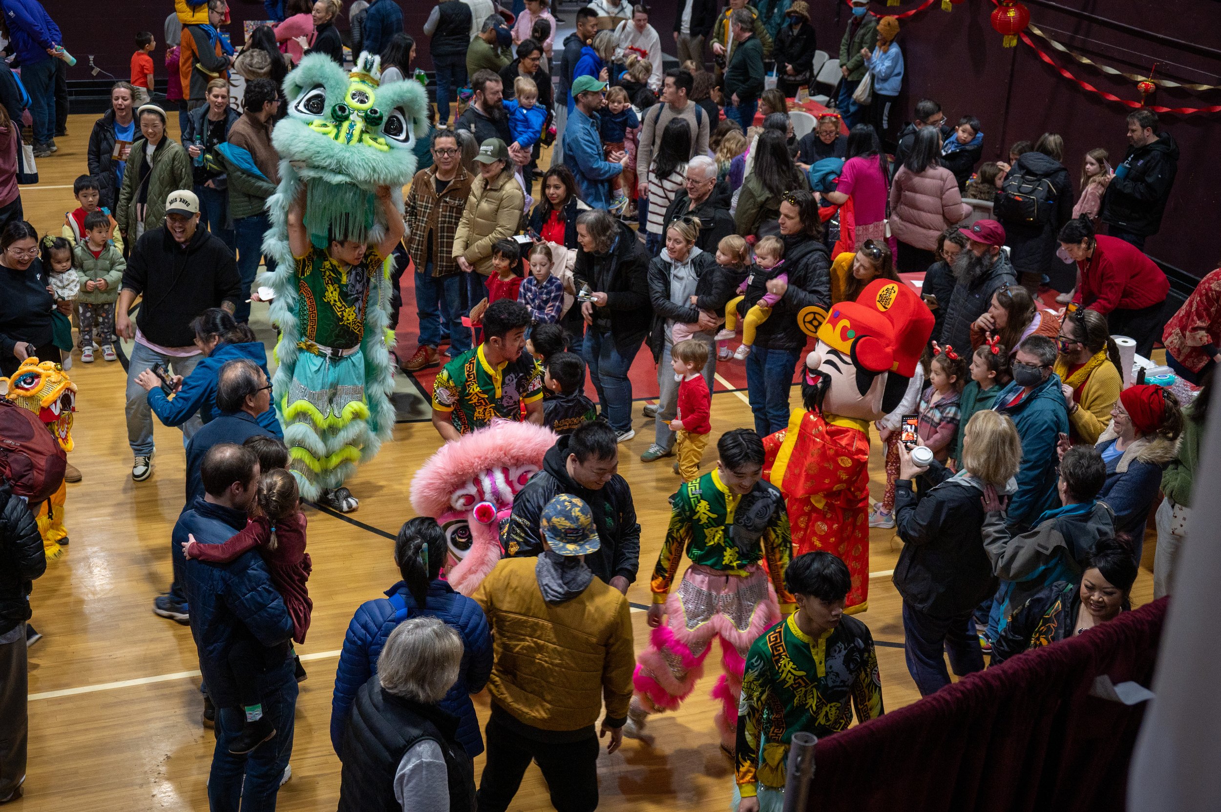MakFai dragon dancers visiting the crowd of people in the Celebration Hall of Lunar New Year Edmonds 