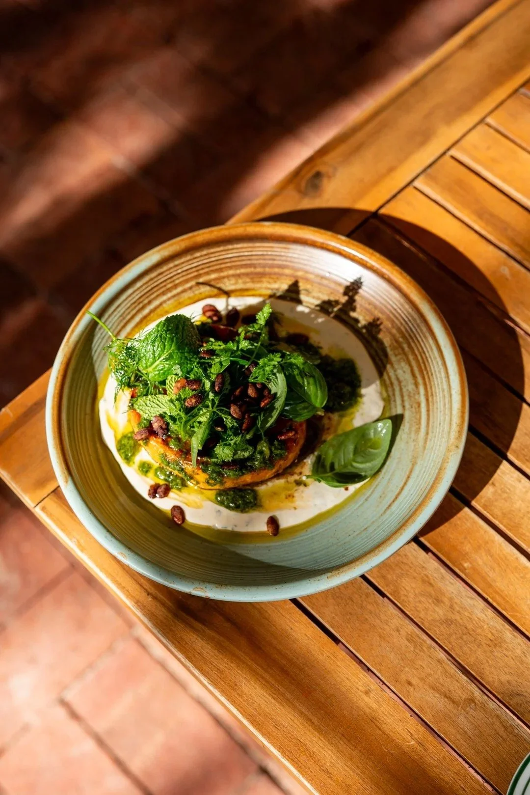 Seasonal dish topped with fresh garden greens at Lost Phoenix Farm