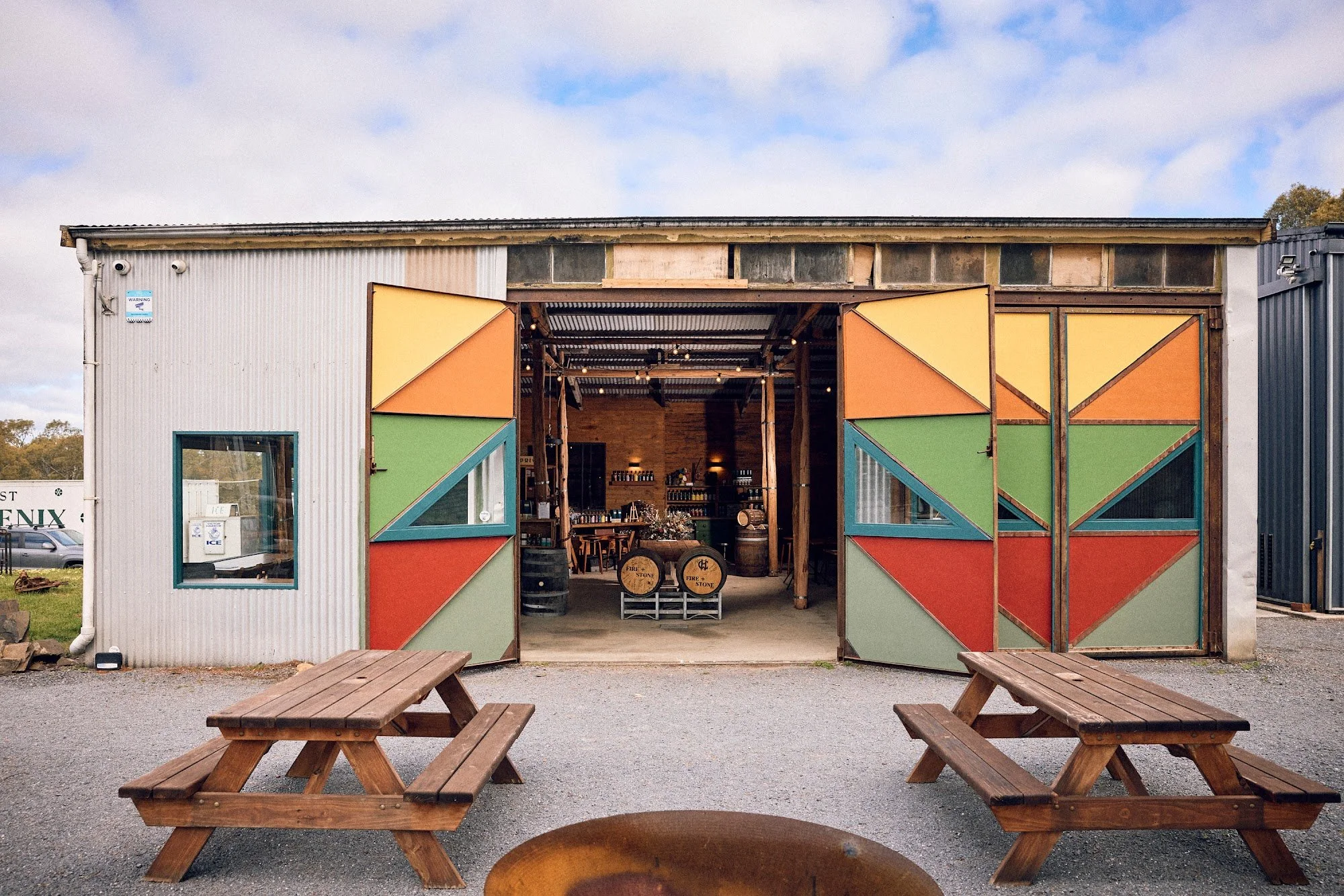 Colourful barn doors open onto The Spirit Door, with picnic tables out front