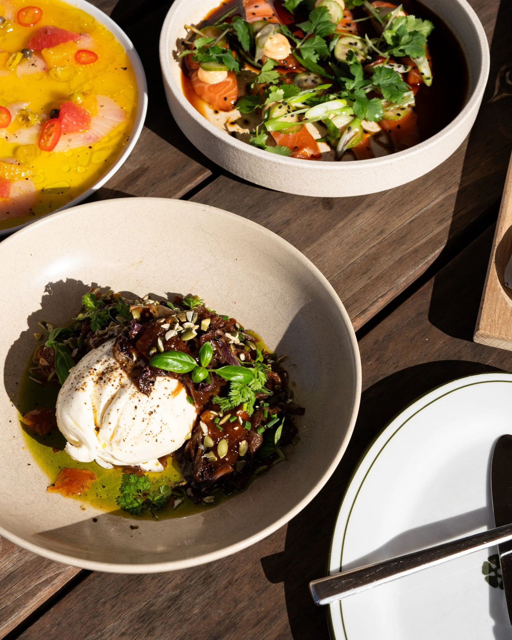 Burrata with roasted vegetables and greens from Lost Phoenix Farm catering
