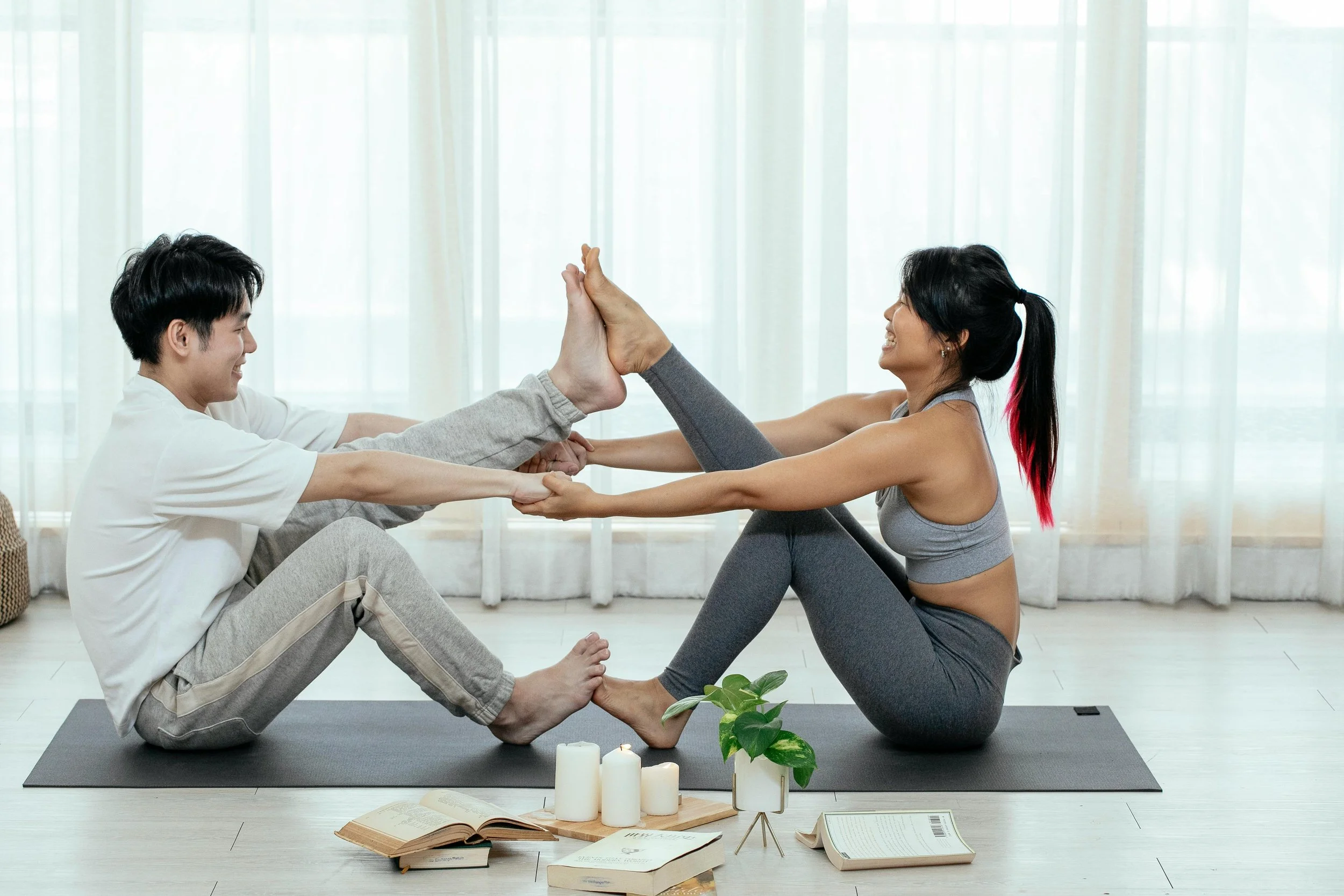 couple doing Navasana posture