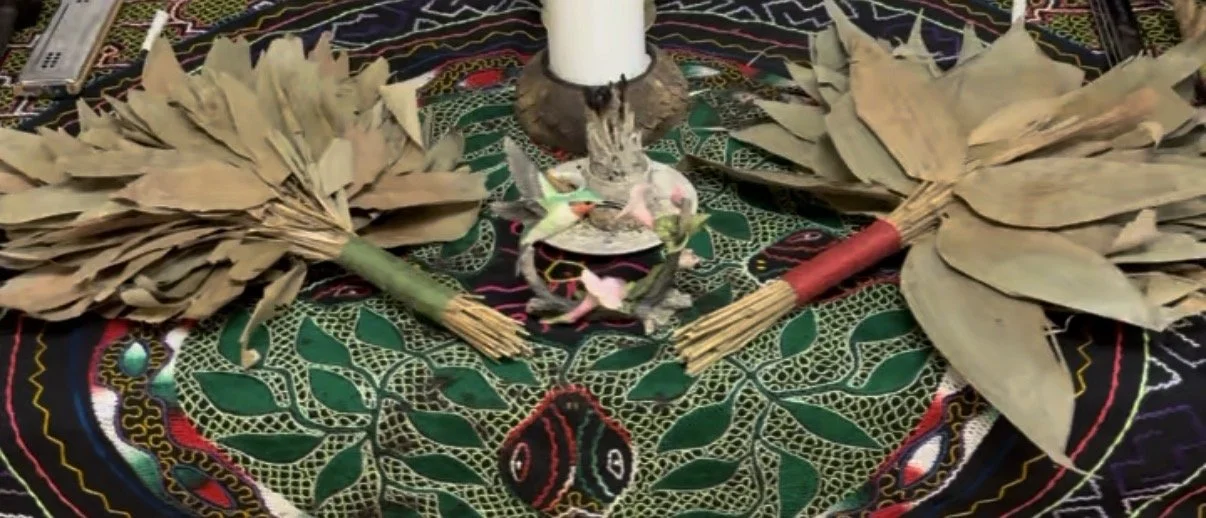 Ayahuasca retreat preparation altar with wayras, incense, candles, and ceremonial tools arranged for sacred prayer.