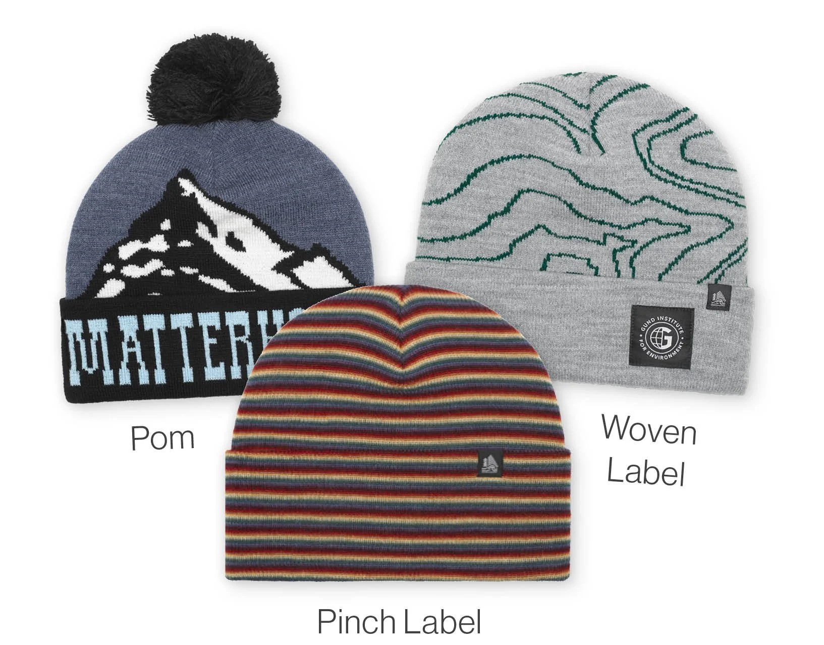 Three beanie hats, one with a mountain design and pom-pom, one with a marbled design and woven label, and one striped with a pinch label.