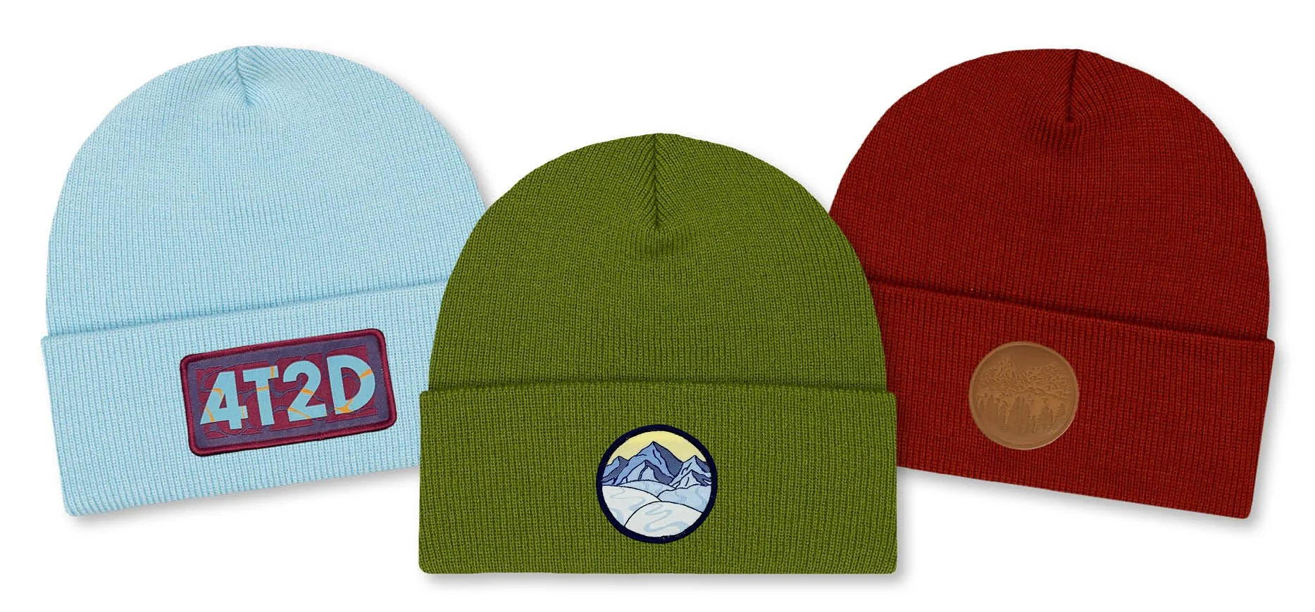 Three knit beanies in blue, green, and red, each with a unique patch design on the front.