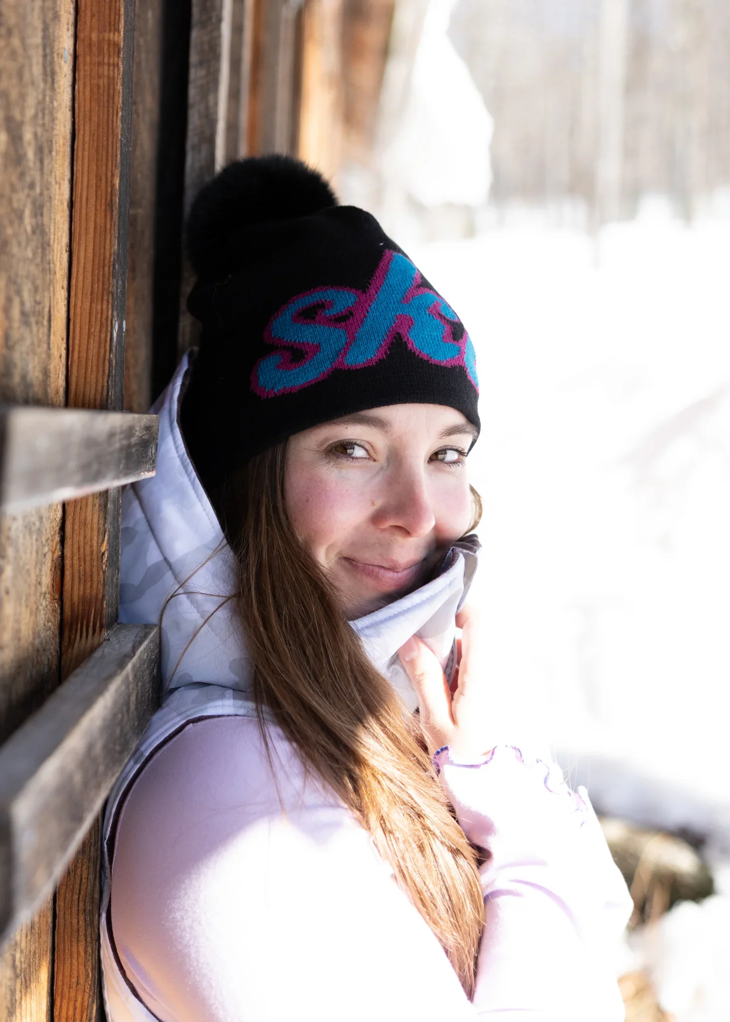 jacquard pom beanie with the word "ski" embroidered on it