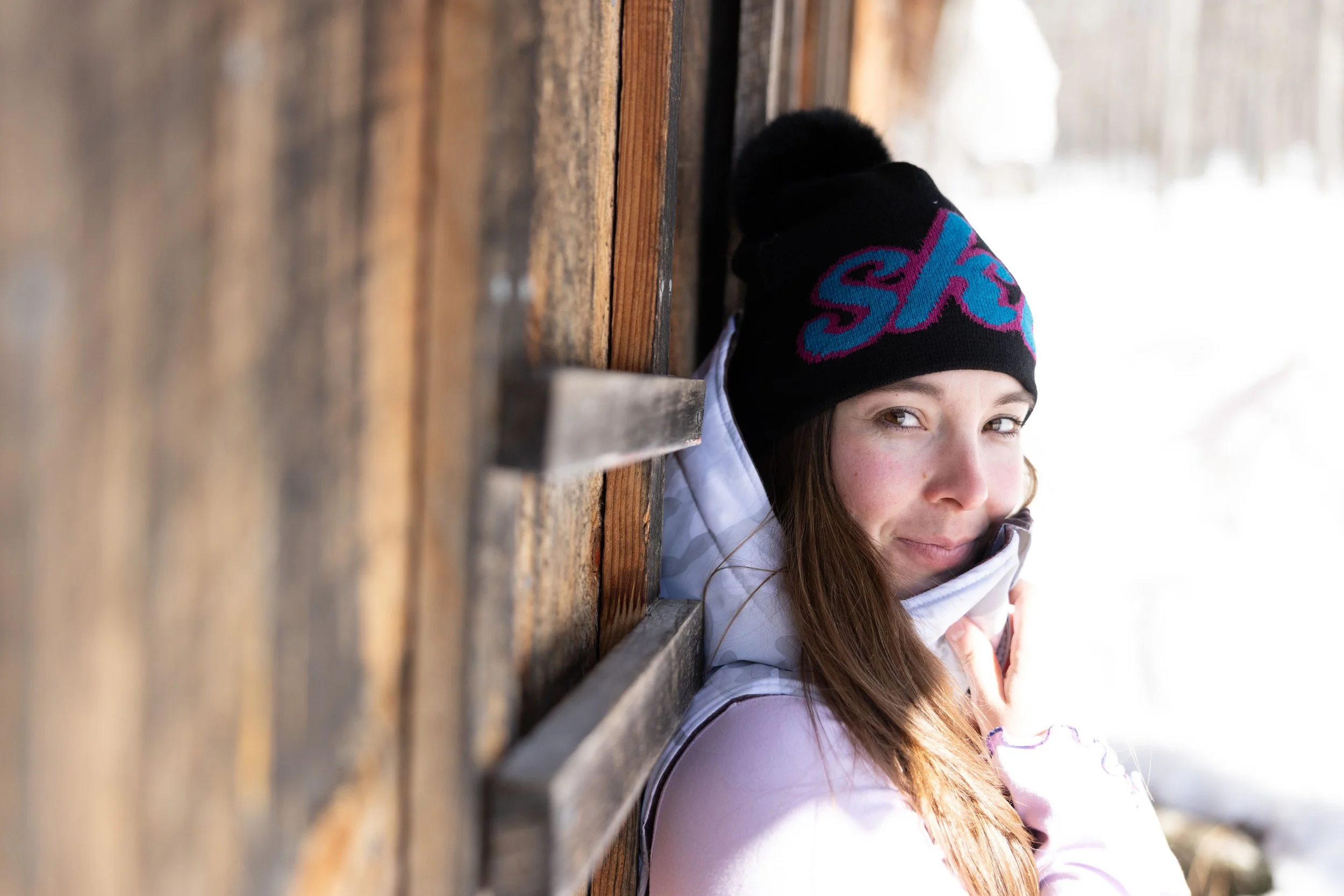 a woman wearing a jacquard pom beanie on a vermont winter day