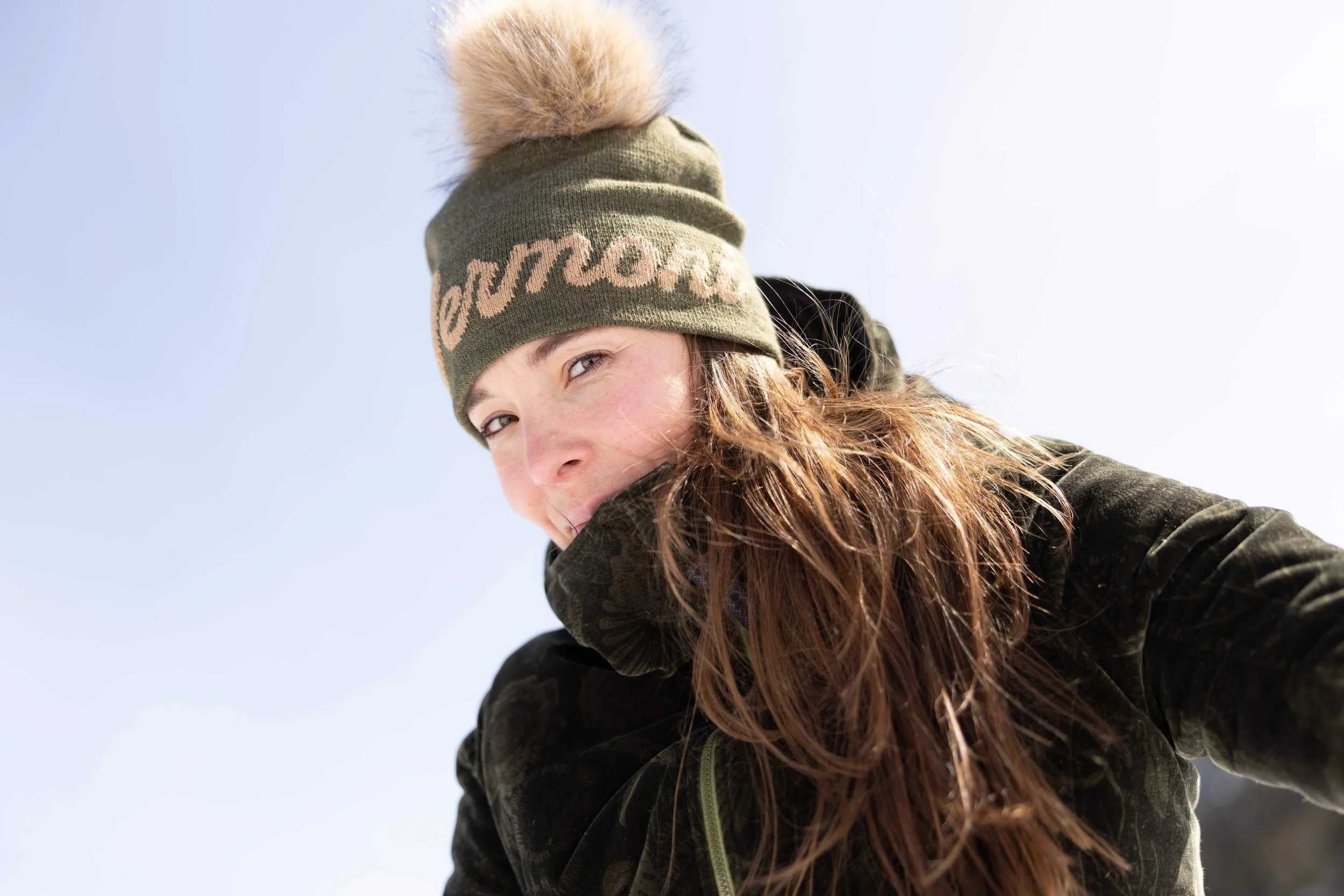 woman wearing a "vermont" pom style beanie made by fourbital factory